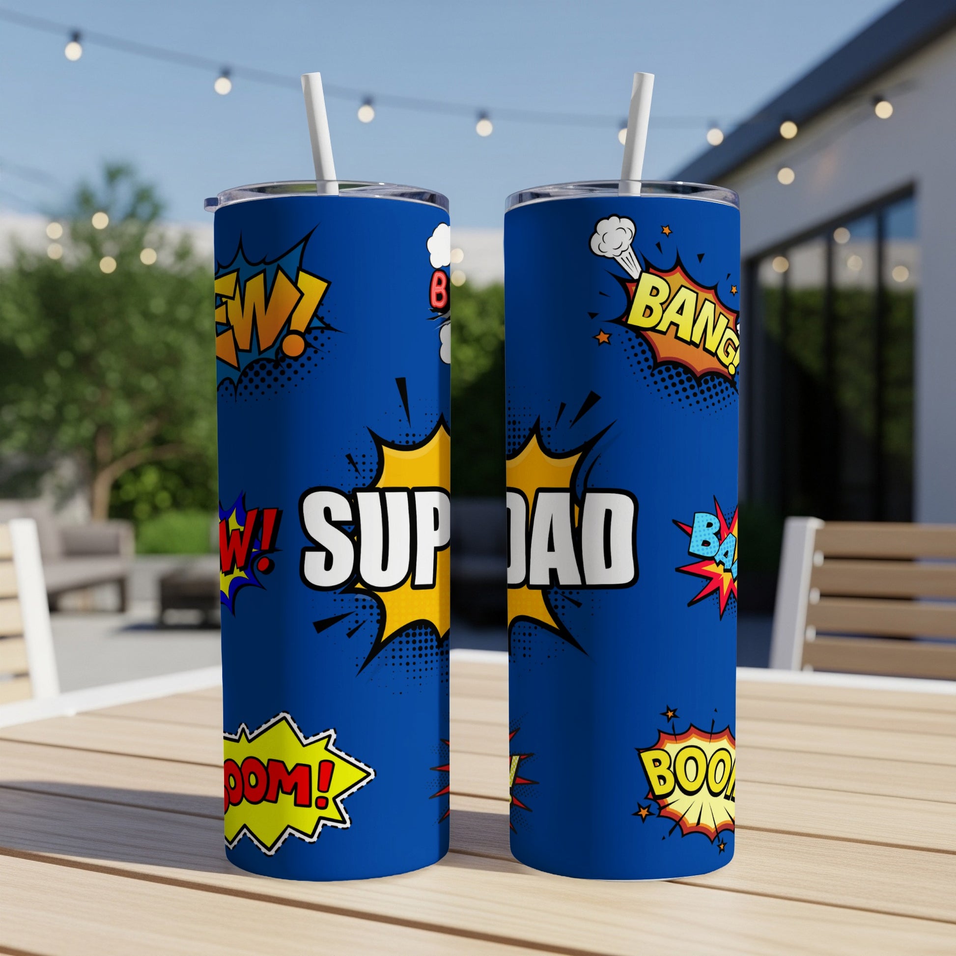 Two blue tumblers with superhero-themed comic book graphics and the text "SUP DAD."
