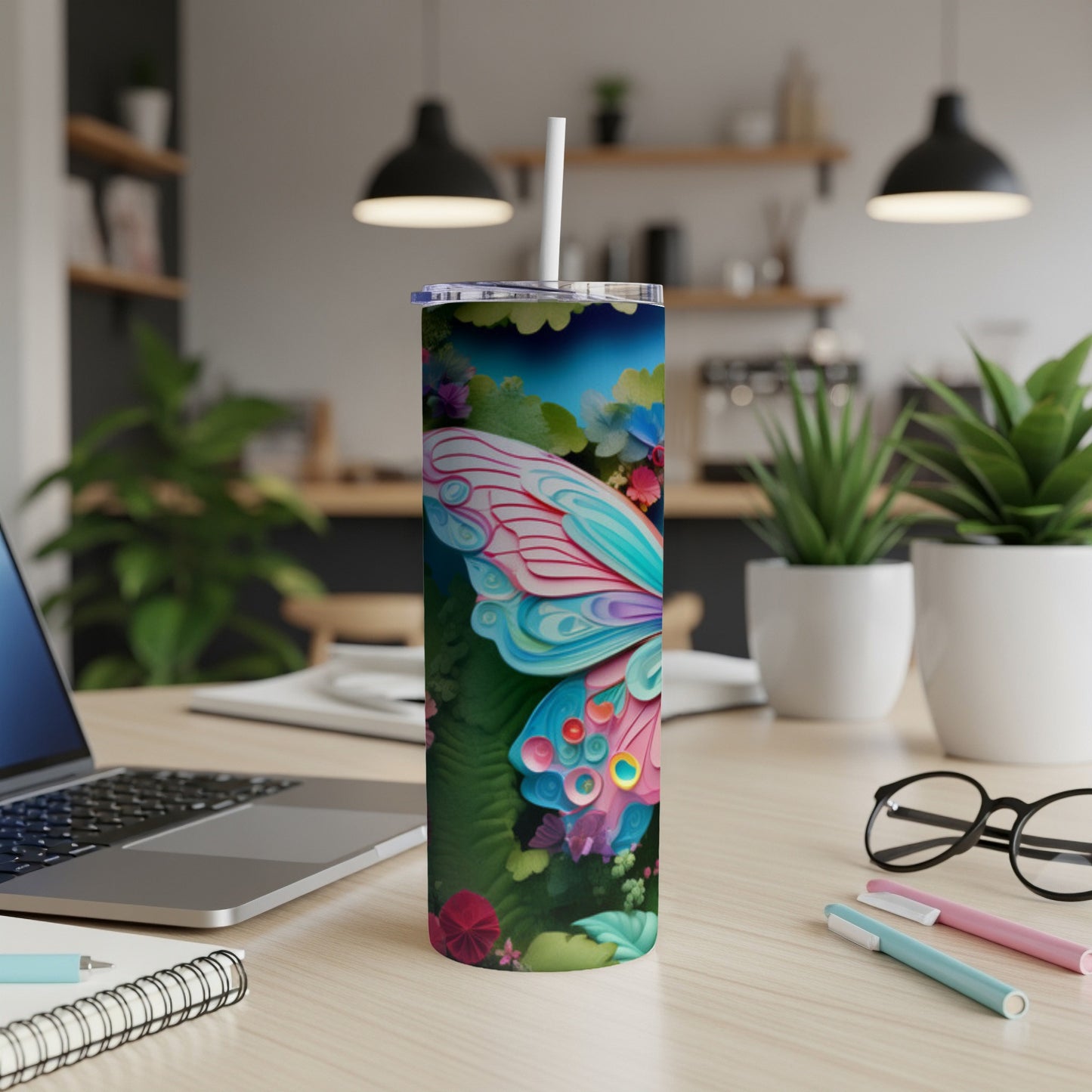 Butterfly wing design on a tall, slim tumbler with a straw.