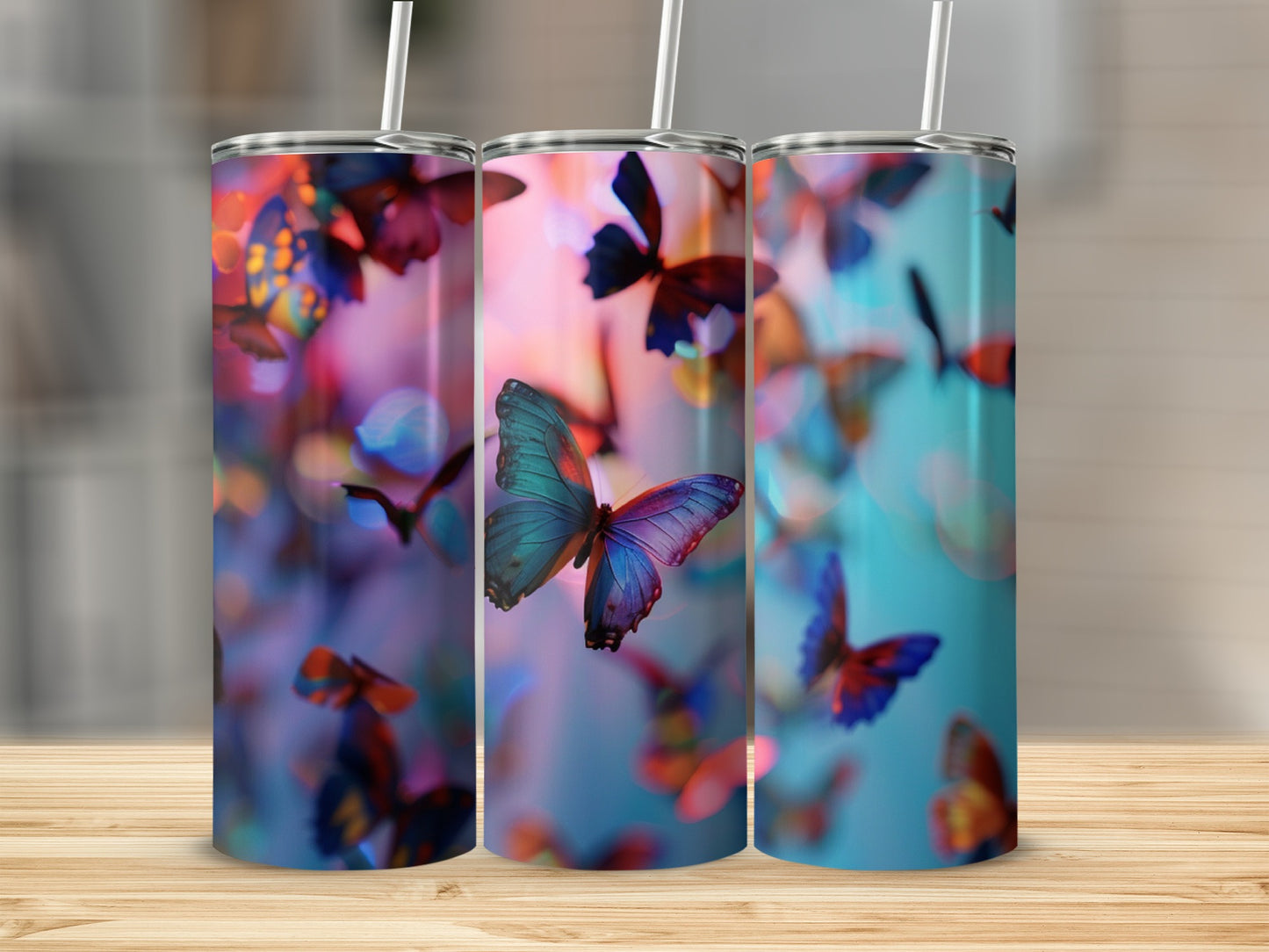 Three tumblers with iridescent butterflies and bokeh effect background.