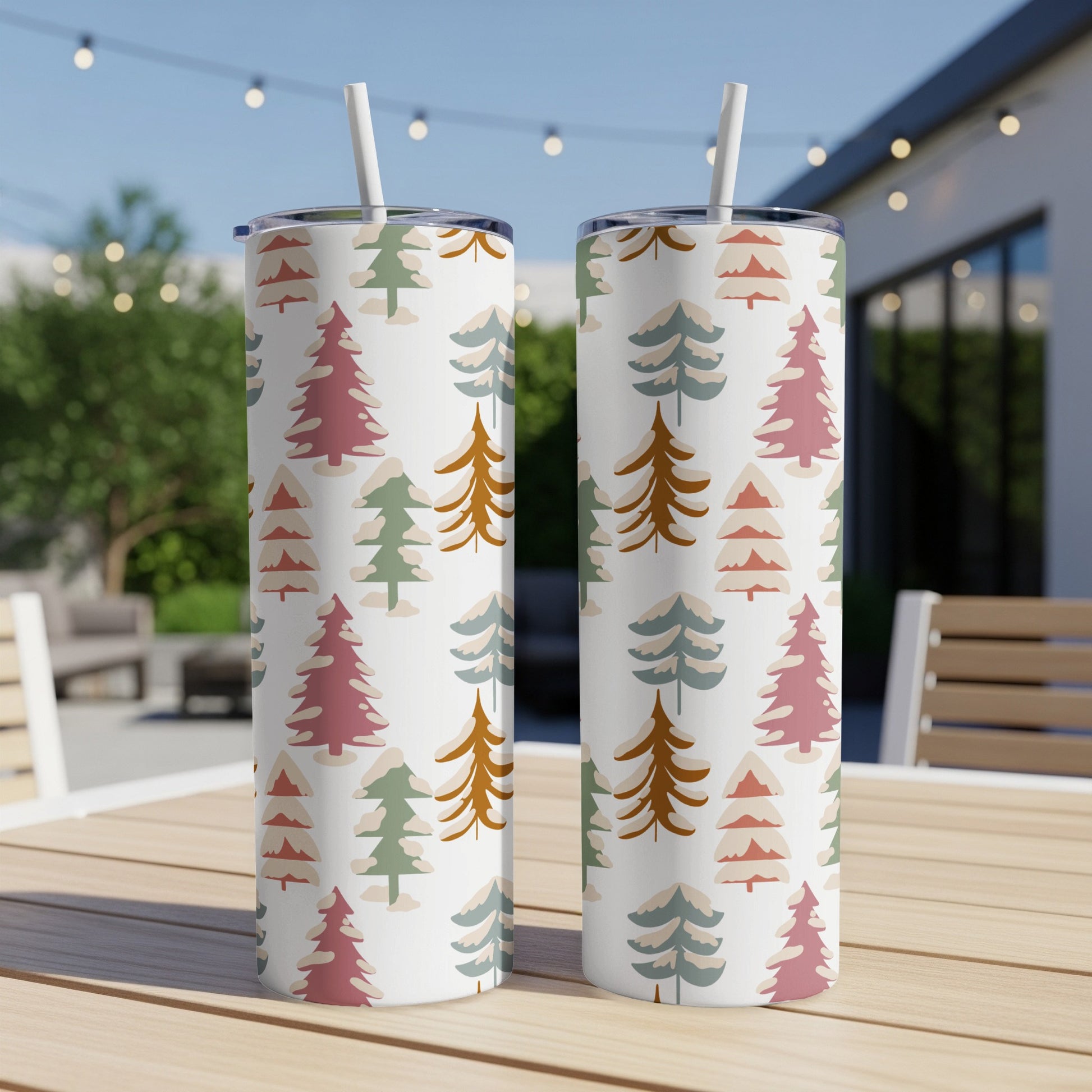 Two tall tumblers with a repeating pattern of stylized Christmas trees.