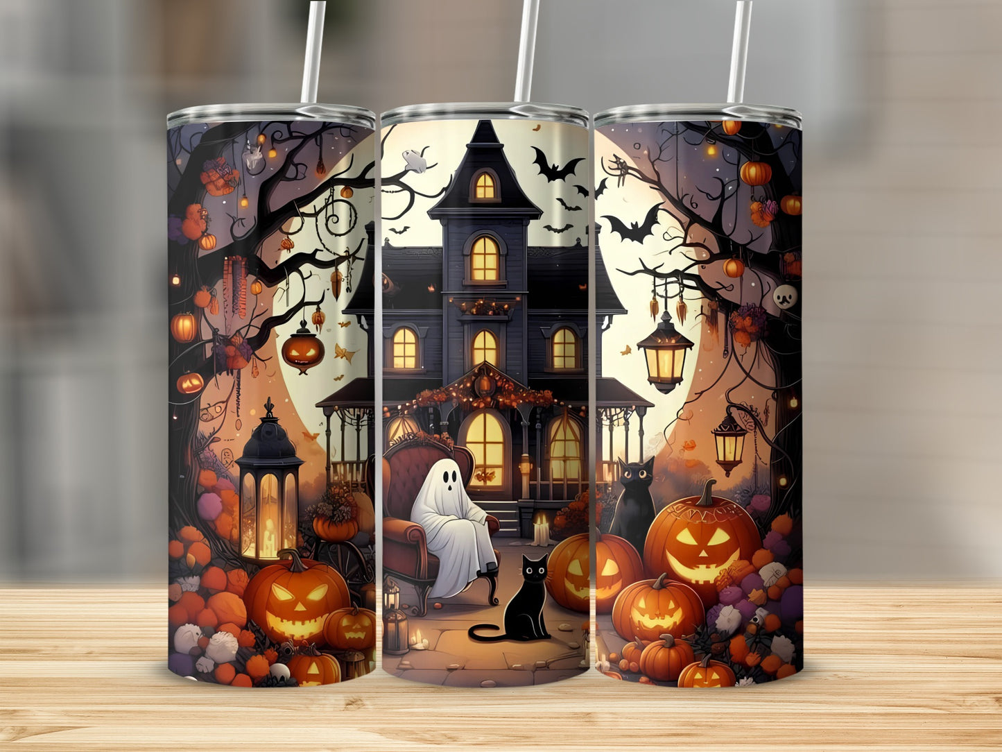 Three tumblers featuring a haunted house, ghosts, black cats, and pumpkins.