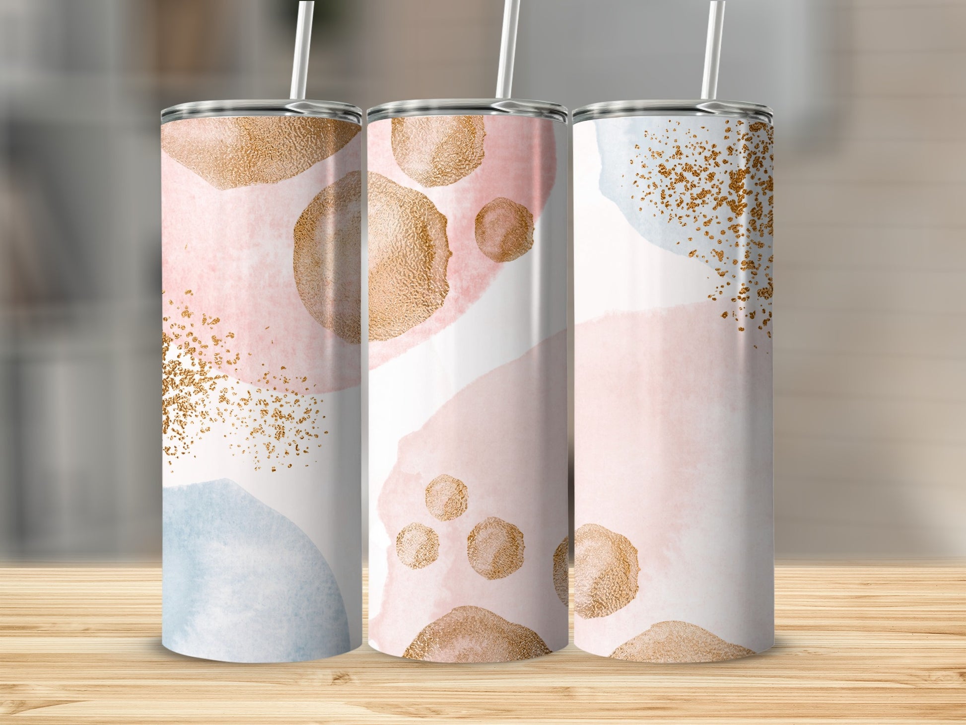 Three tumblers with abstract watercolor and gold speckle designs.