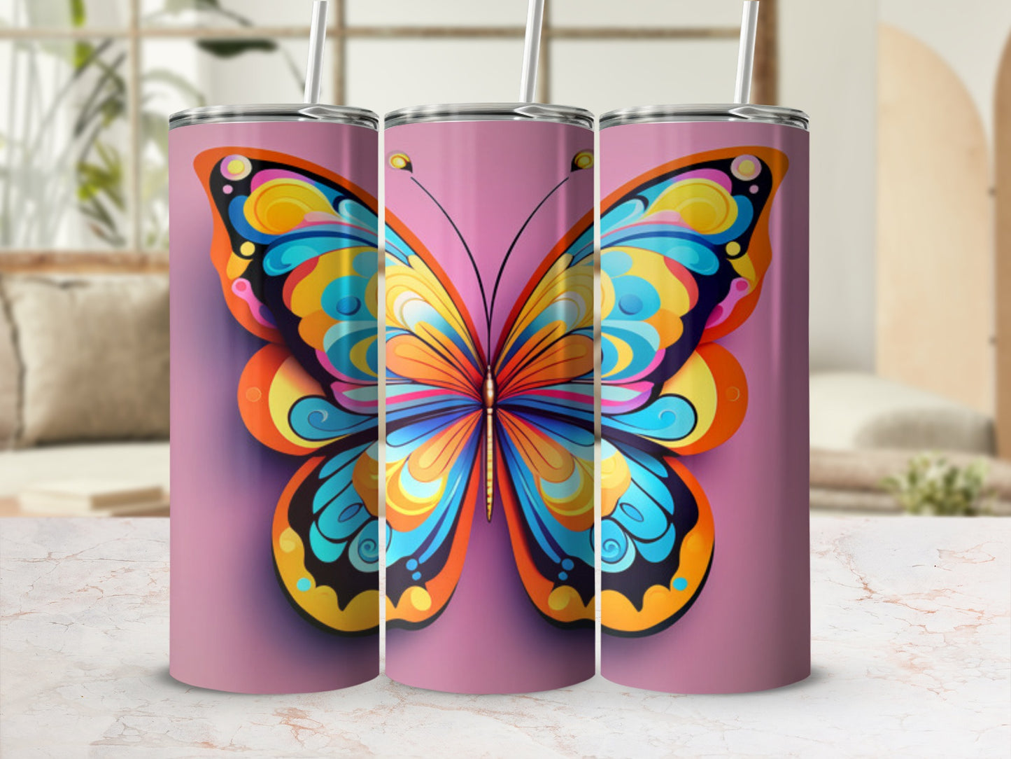 Colorful butterfly design on three stainless steel tumblers with straws.