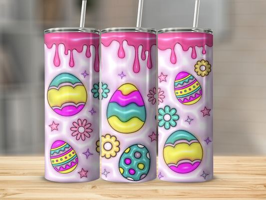 Pink glitter drips over Easter eggs and flowers on a tumbler.