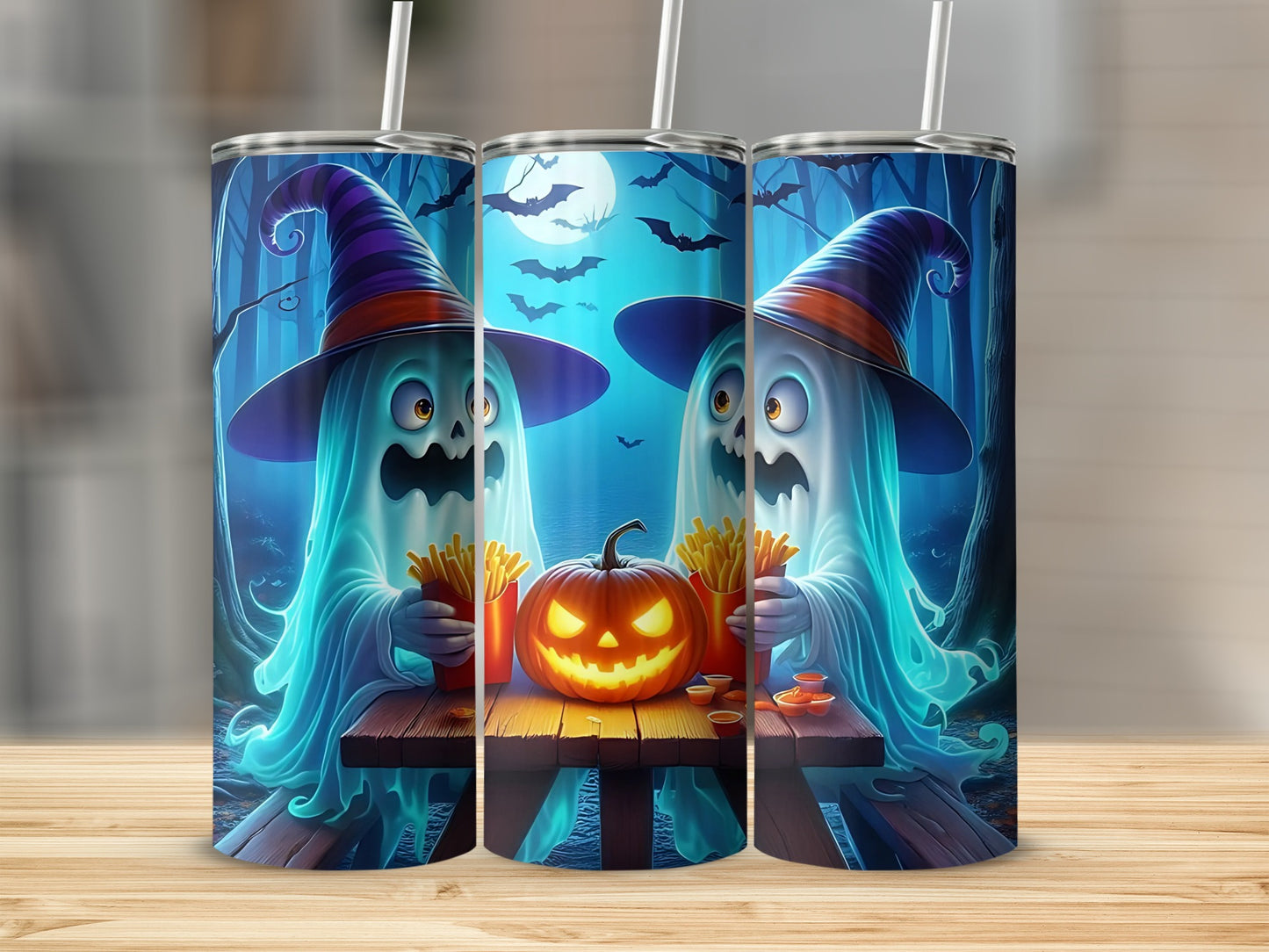 Two ghosts in witch hats eat fries and dip next to a jack-o'-lantern.