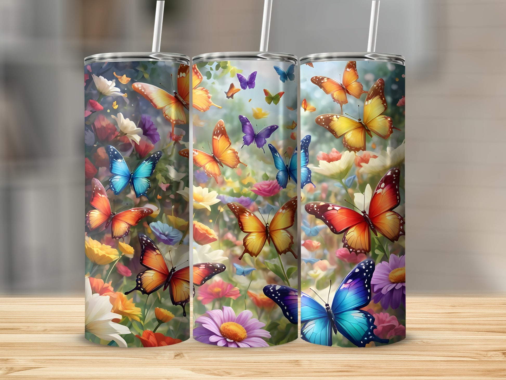 Three tumblers featuring colorful butterflies and flowers.