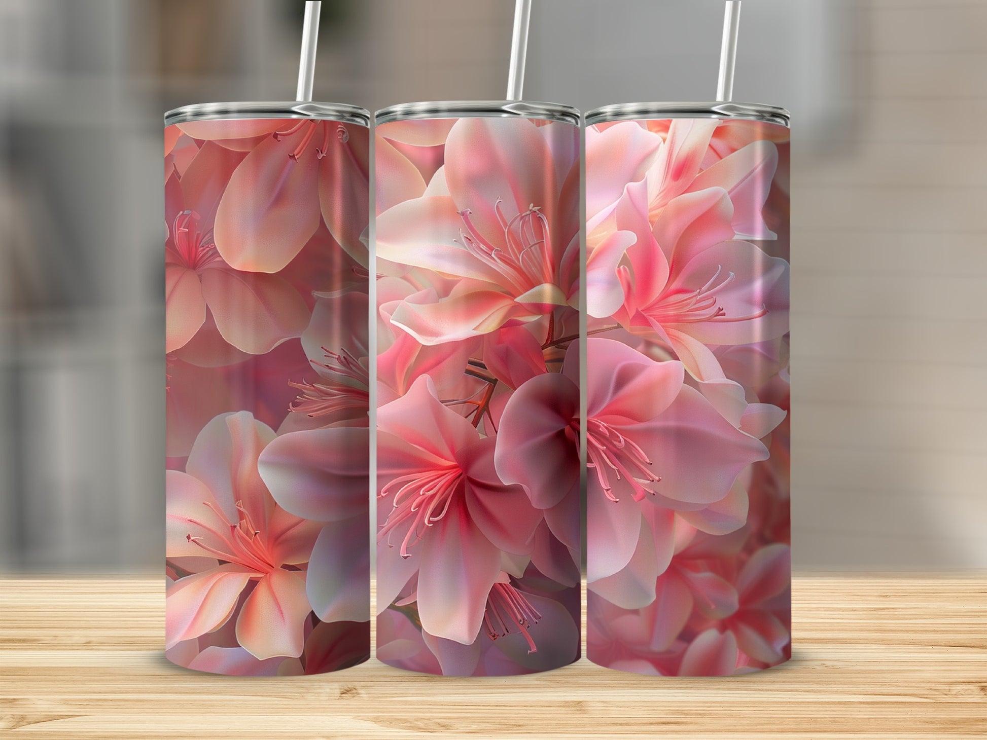 Three tumblers with pink floral pattern, shown on a wooden surface.