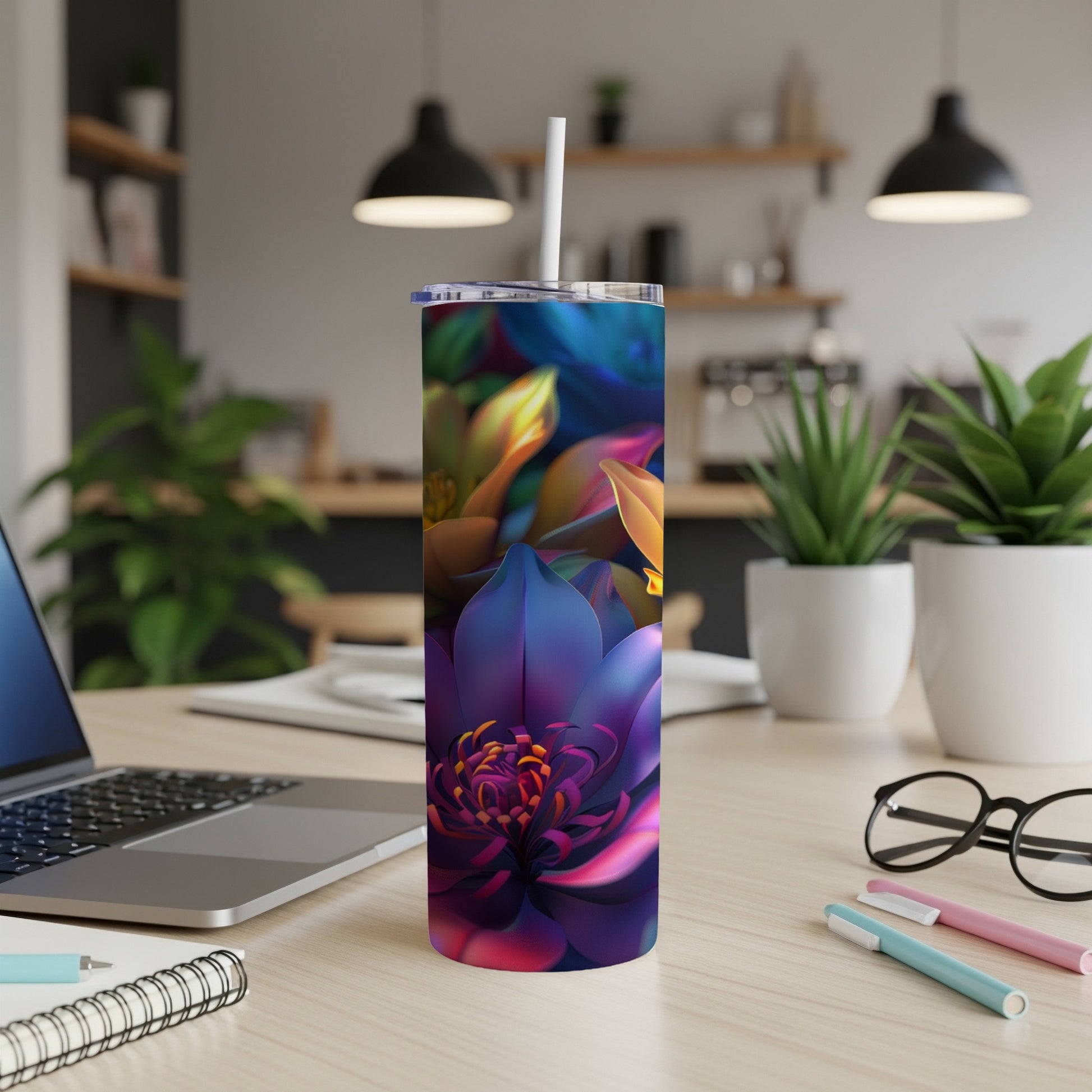 Purple, blue, and yellow floral pattern on a tall, skinny tumbler with a straw.