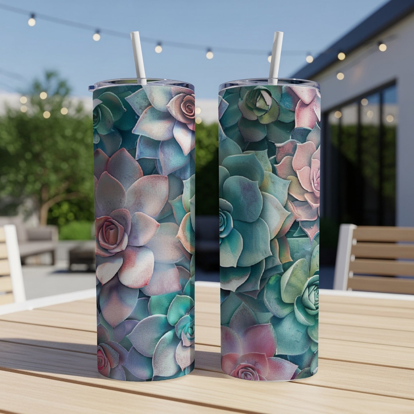 Two tumblers with a succulent floral pattern sit on a table outdoors.