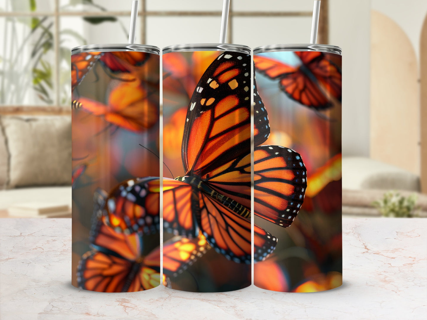 Monarch butterflies on orange and black patterned tumbler with straw.