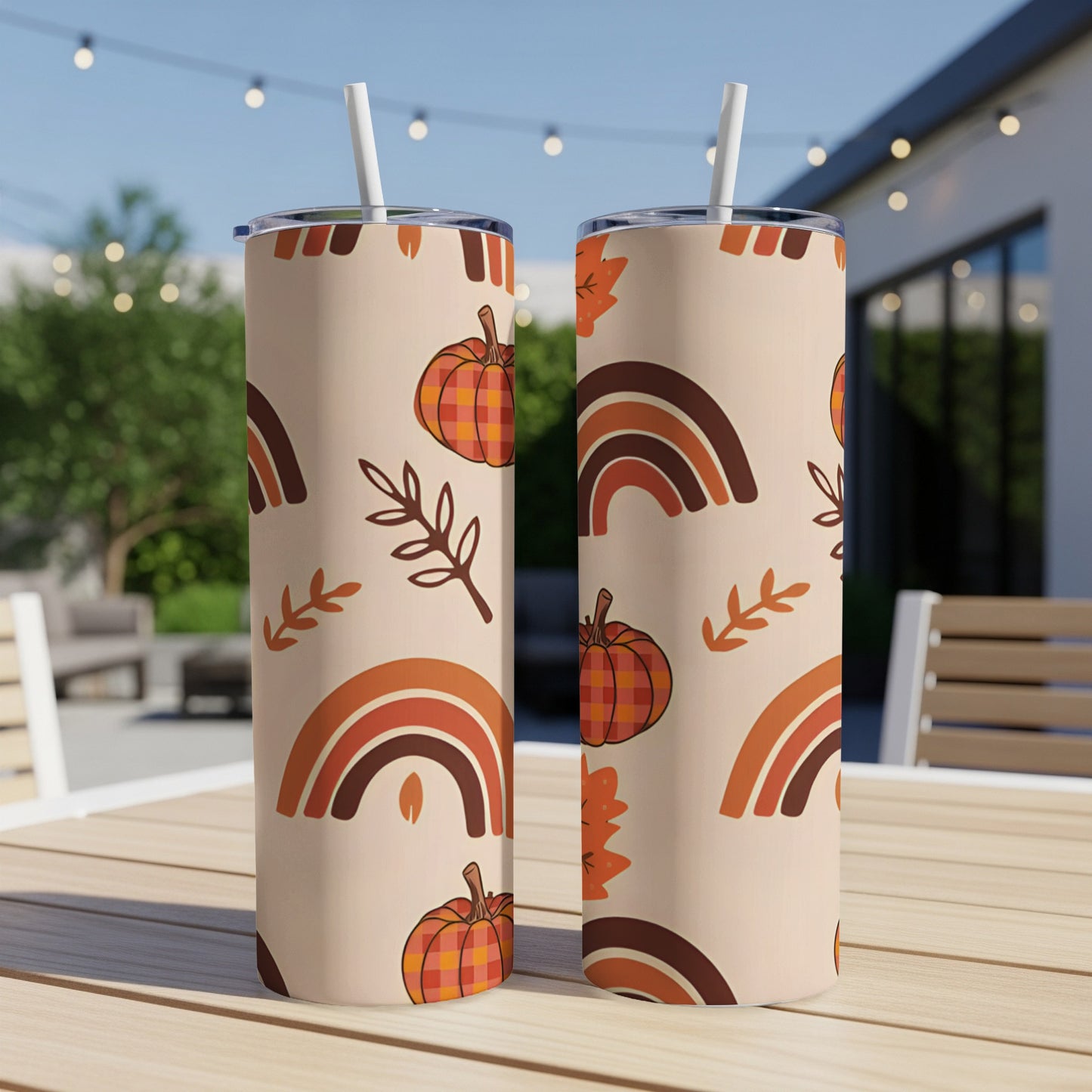 Two tall tumblers with a fall-themed pattern of pumpkins and rainbows.