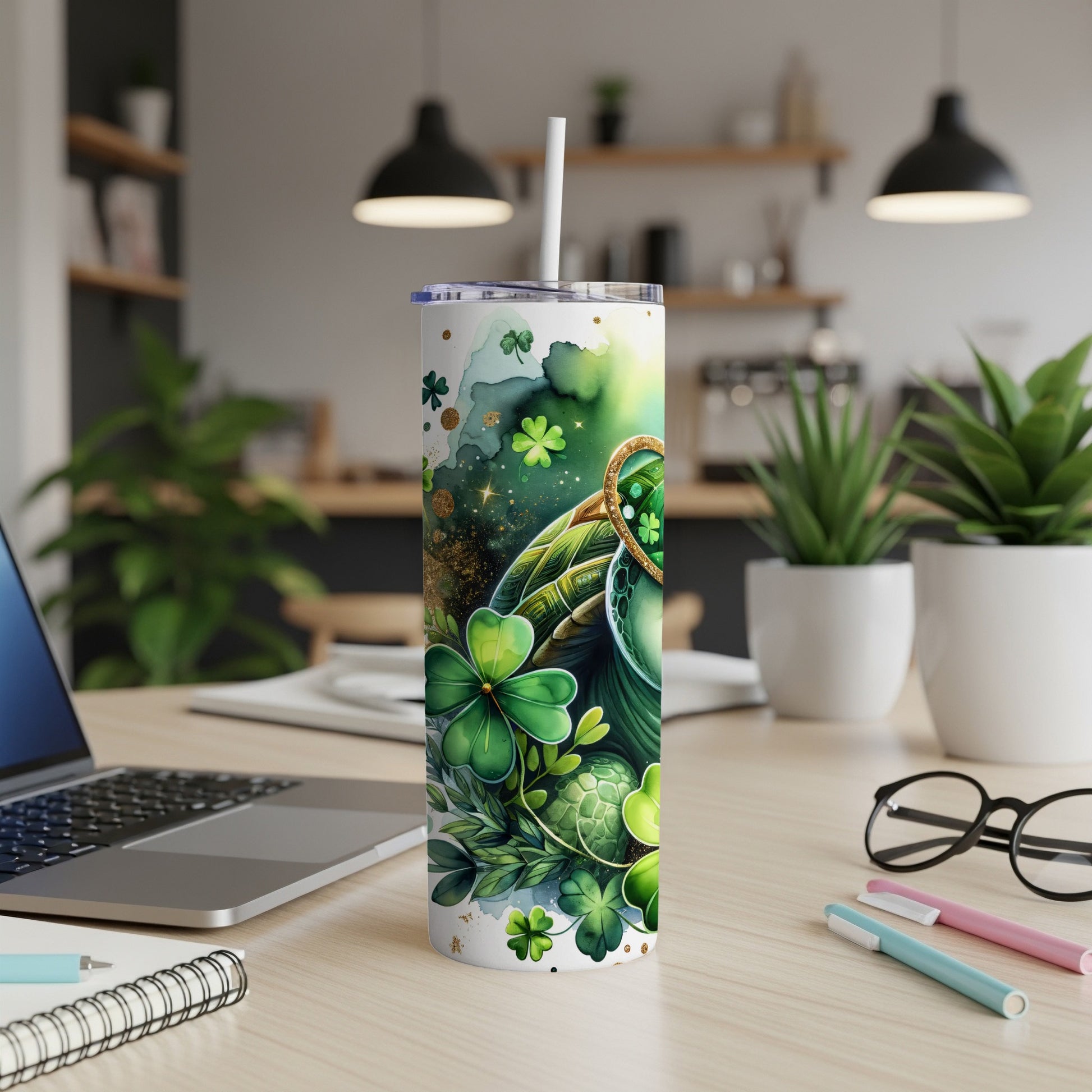 Green St. Patrick's Day tumbler with shamrocks and gold accents on desk.
