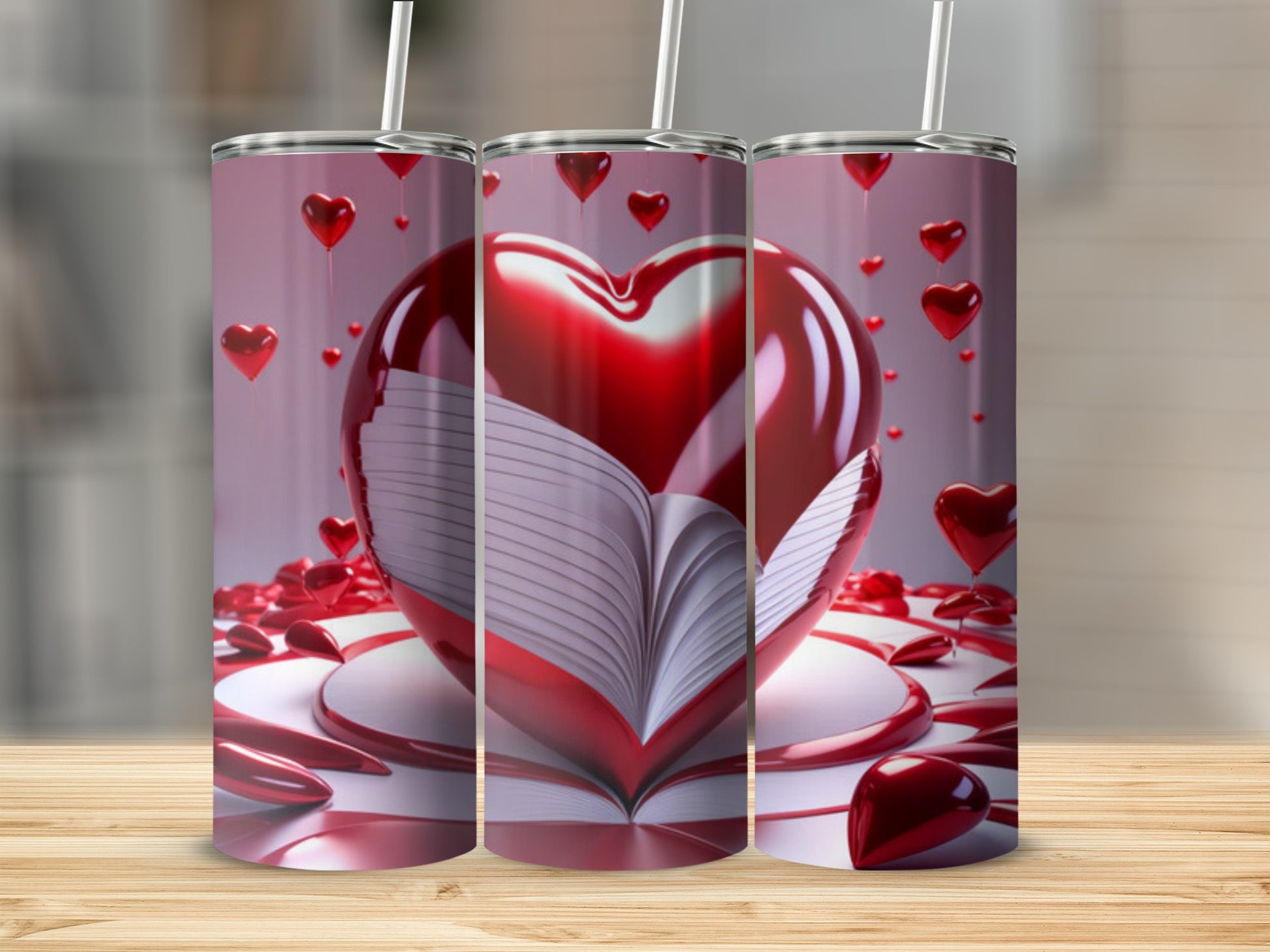 Three tumblers displaying an open book with a large heart on top.