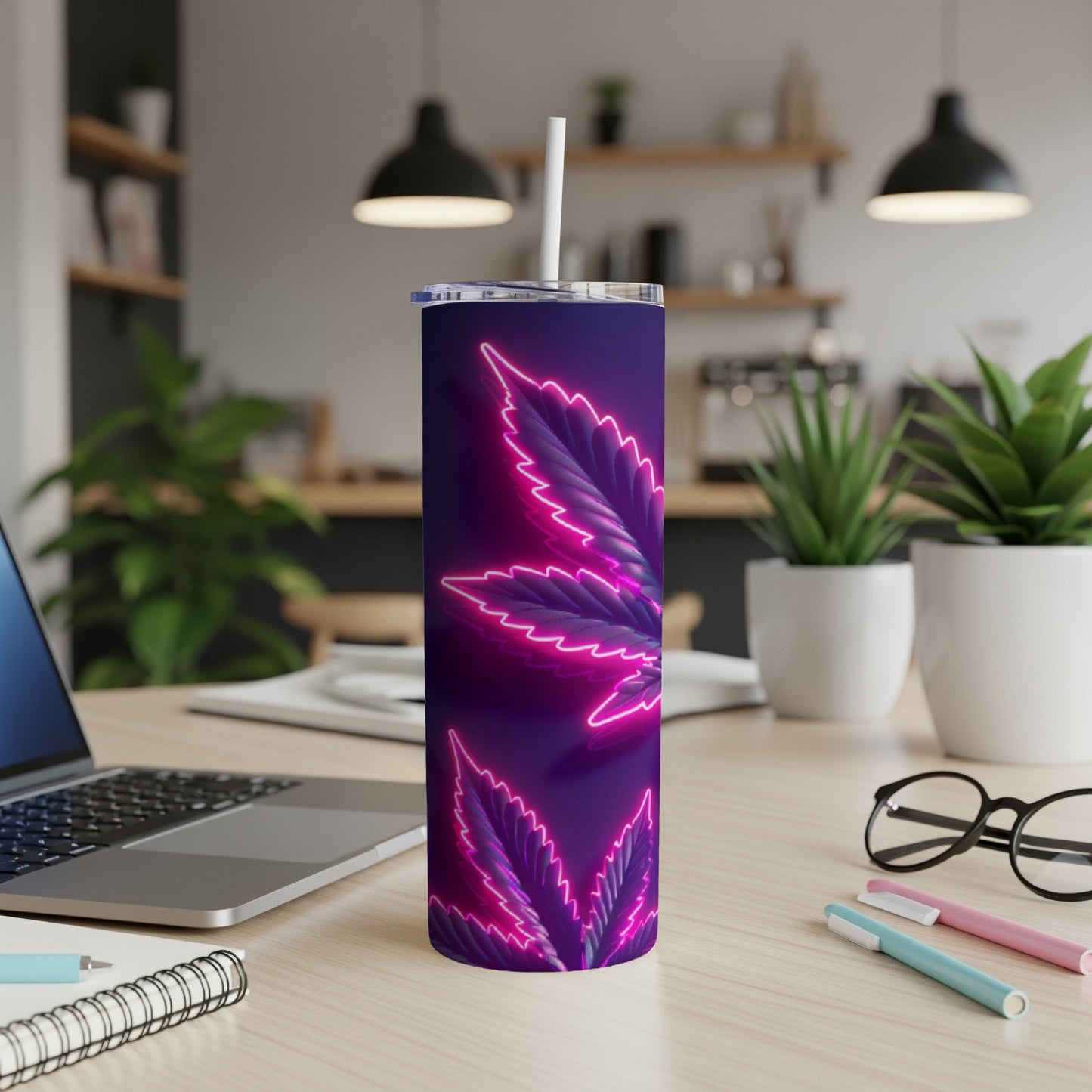 Purple cannabis leaf design on a dark tumbler with a straw.