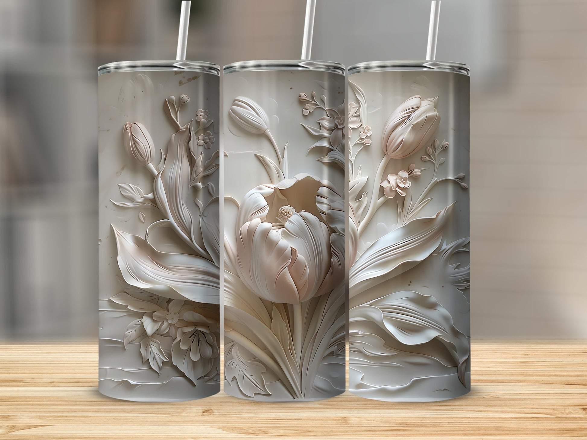 Three white textured tumblers with embossed floral tulip designs and straws.