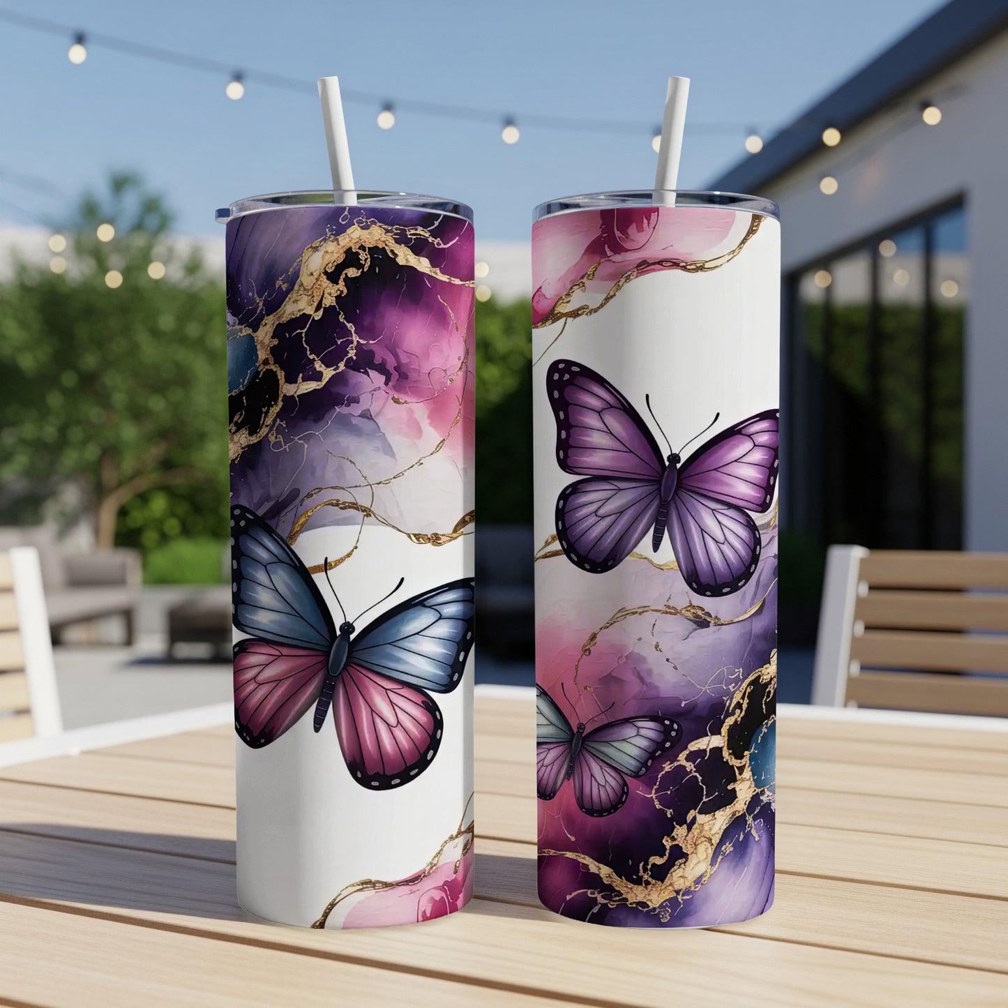 Two white tumblers with purple and gold abstract marble design and butterflies.