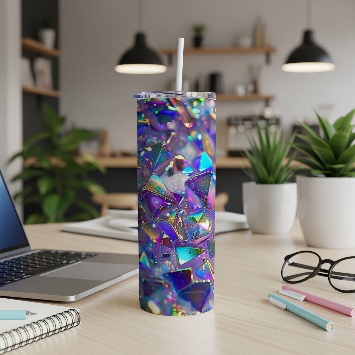 Iridescent geometric tumbler with straw on a desk.
