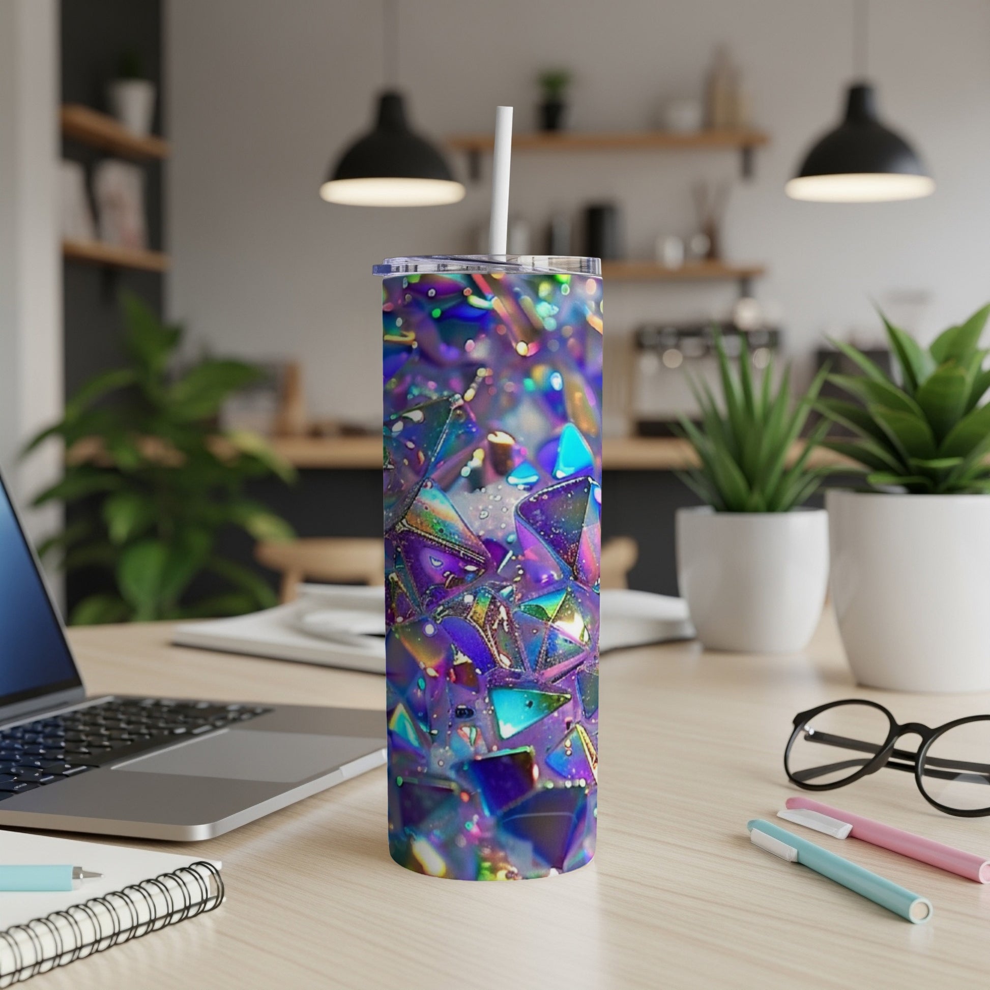 Iridescent geometric tumbler with straw on a desk.