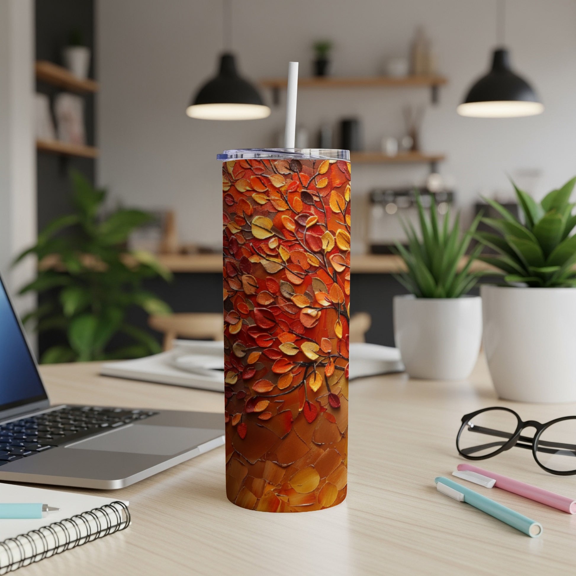 Tall tumbler with textured autumn leaves pattern.
