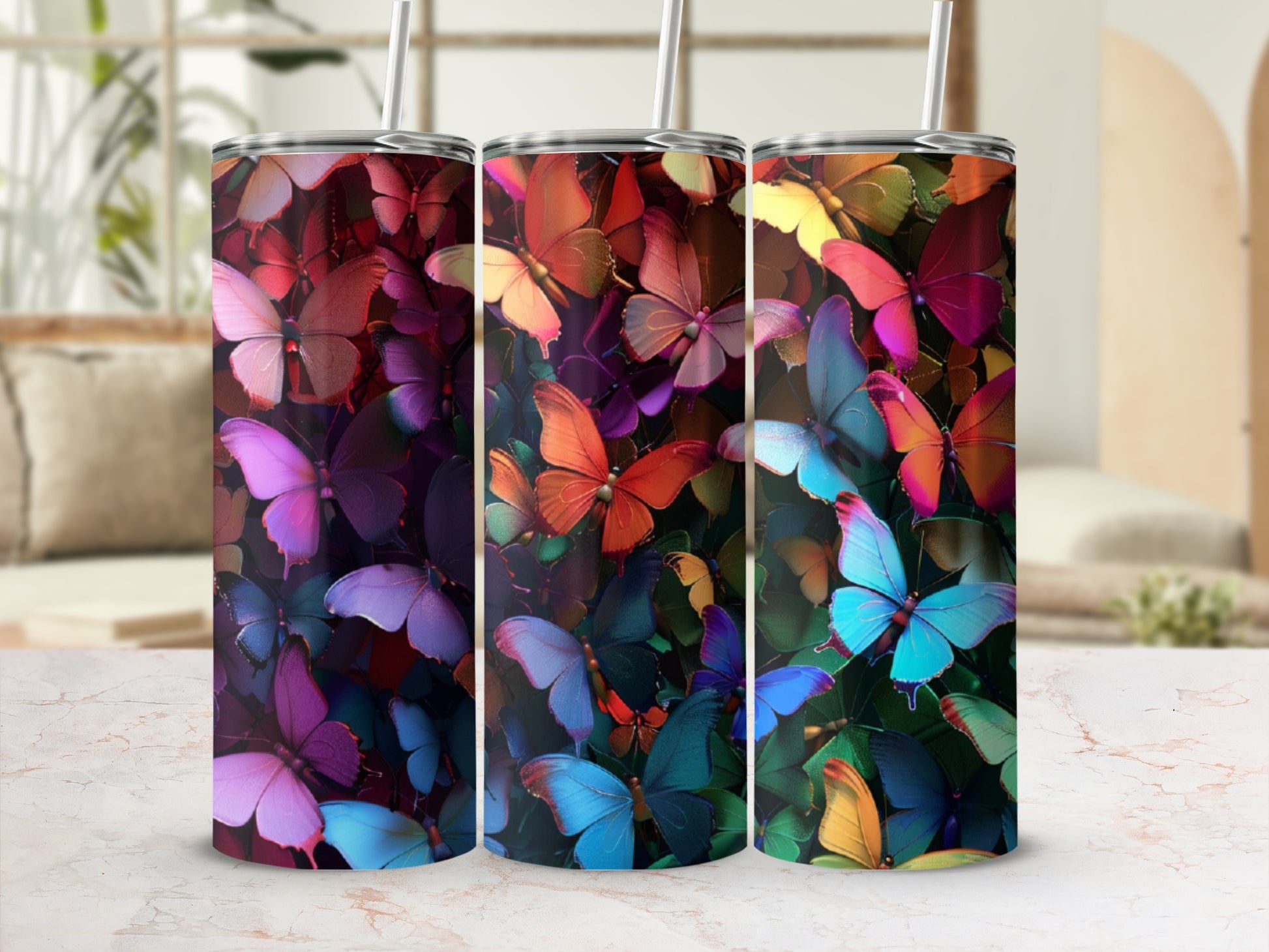 Three tumblers featuring vibrant, overlapping butterfly designs in various colors.