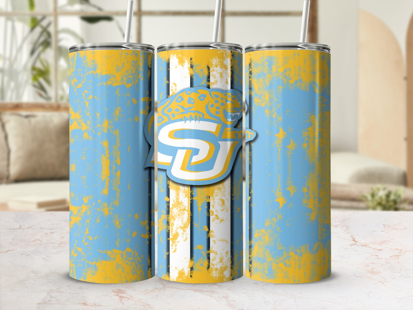 Three tumblers with blue, yellow, and white distressed stripe and splatter designs.