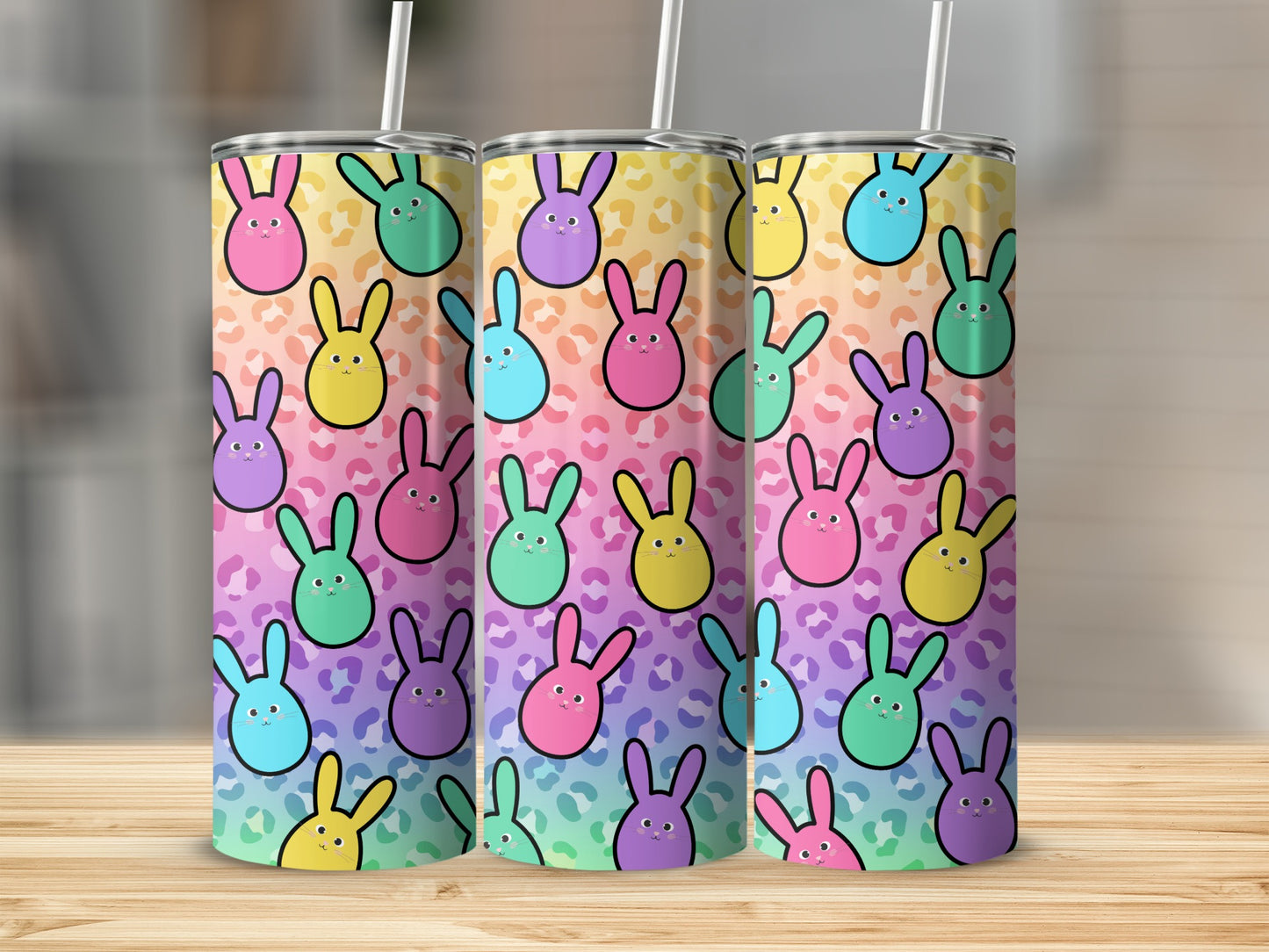Three pastel bunny-patterned tumblers with leopard print background.