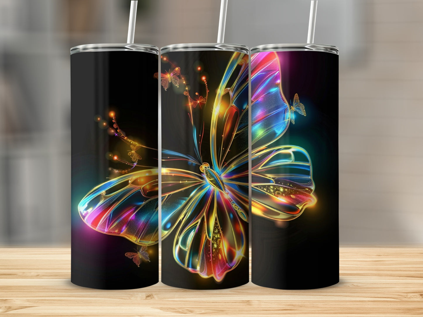 Three tumblers with colorful, abstract butterfly designs on a black background.