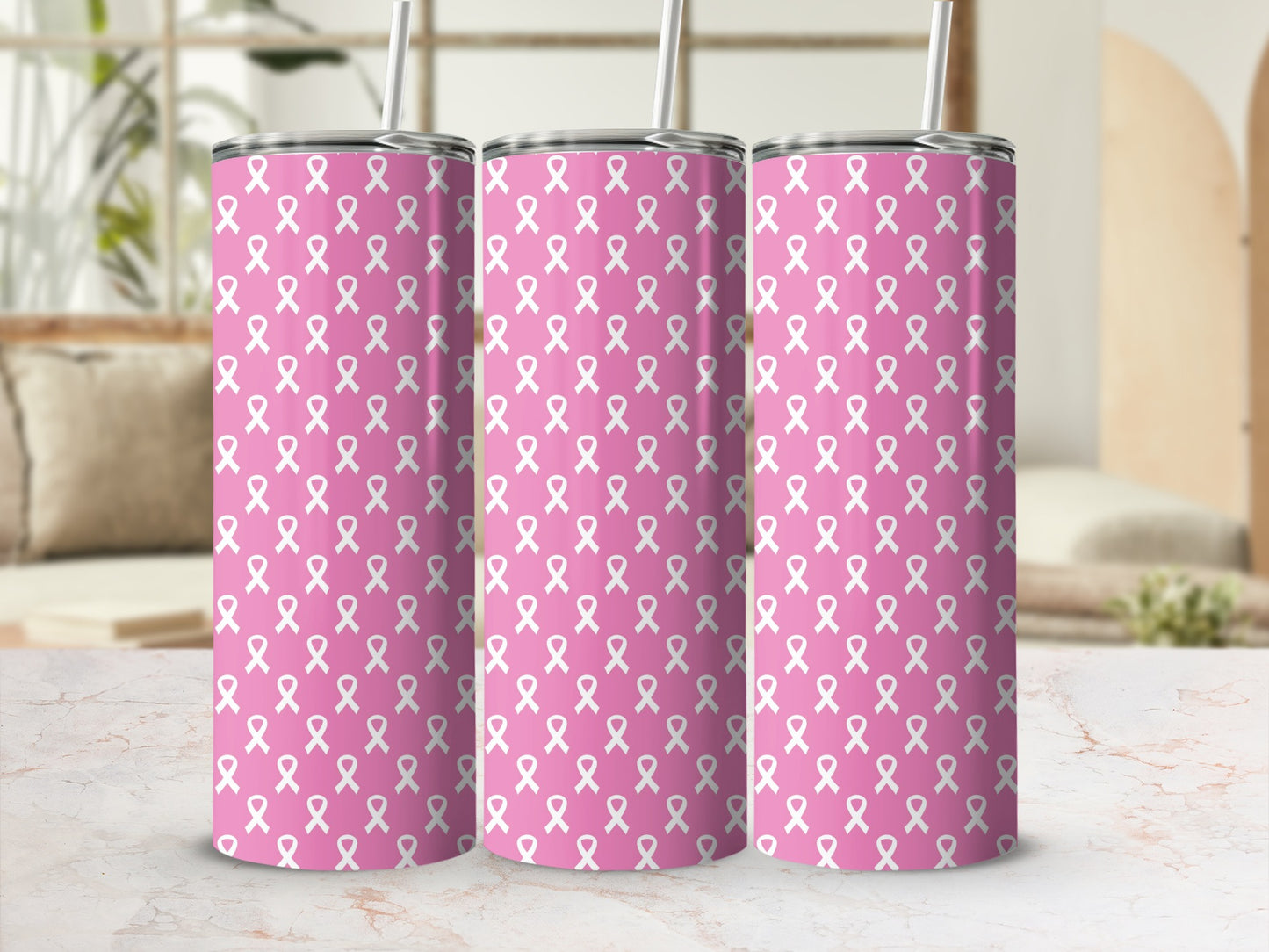 Three pink tumblers with white ribbon pattern, each with a straw.