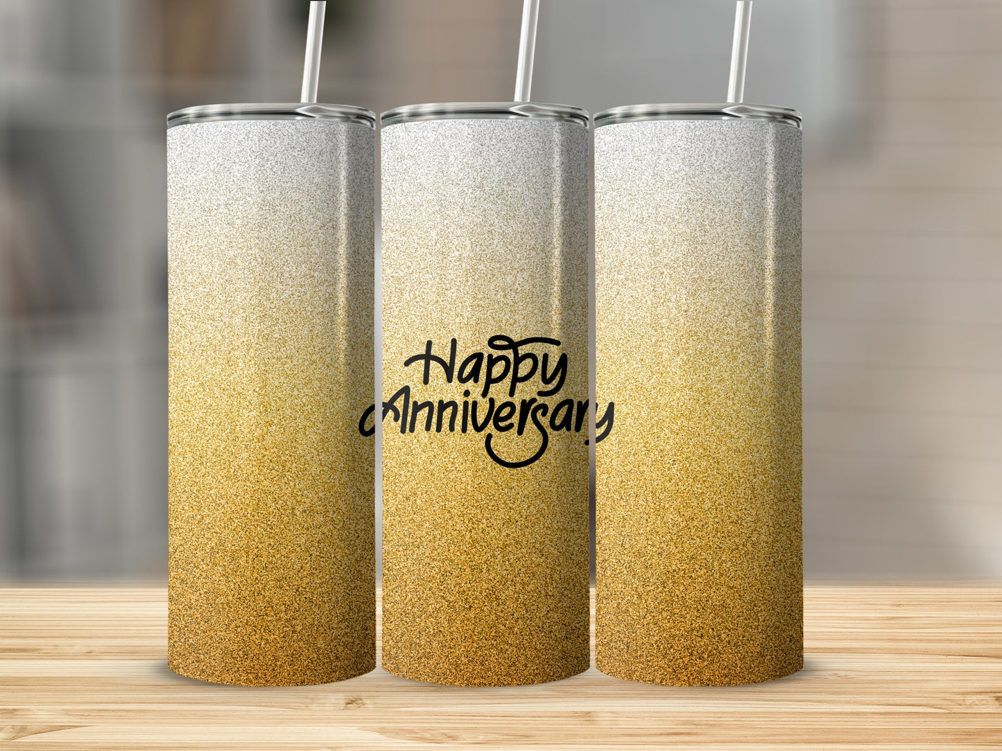 Three glitter tumblers with "Happy Anniversary" text on the middle one.