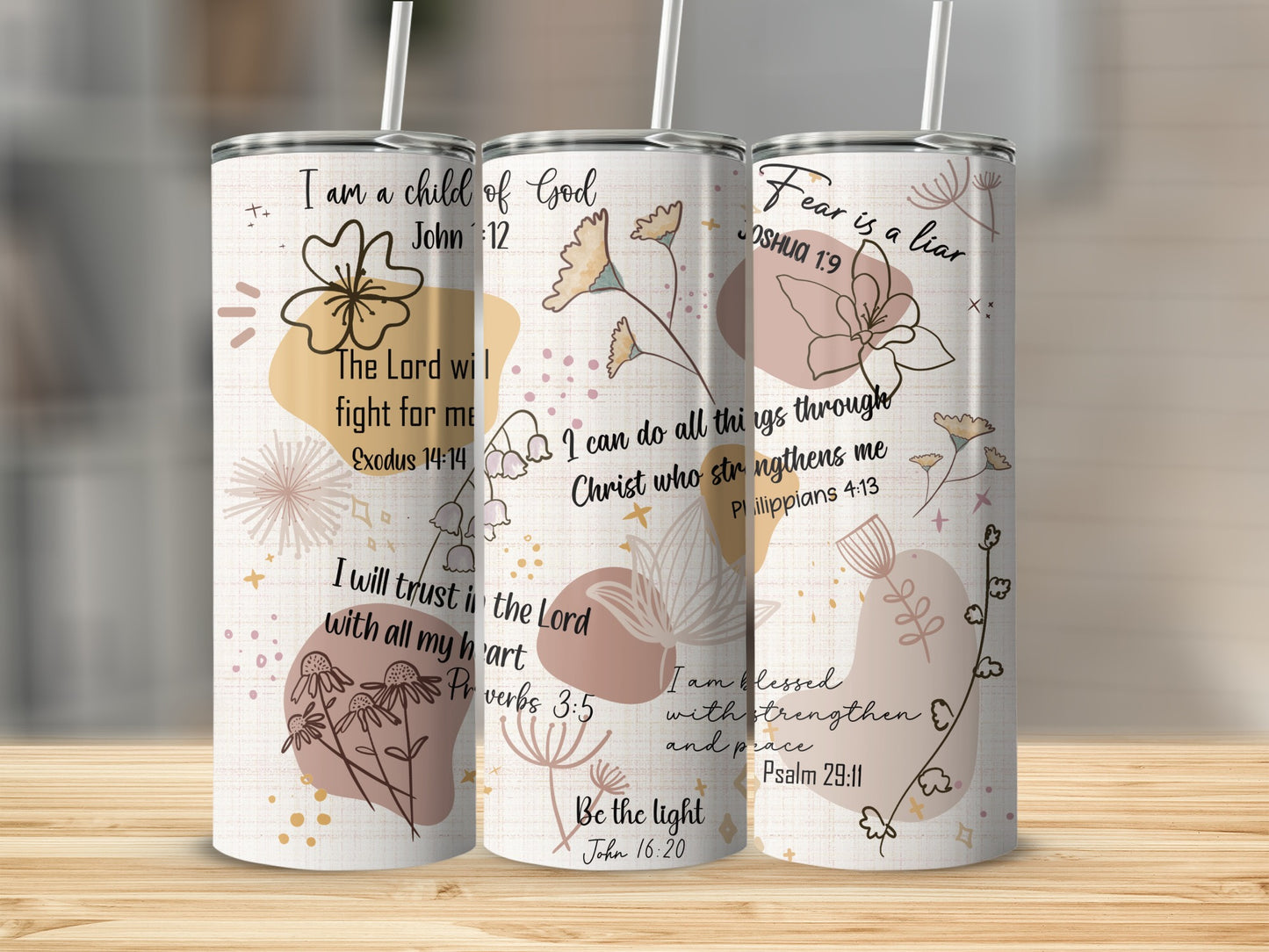 Three tumblers with religious quotes and floral designs on a neutral background.