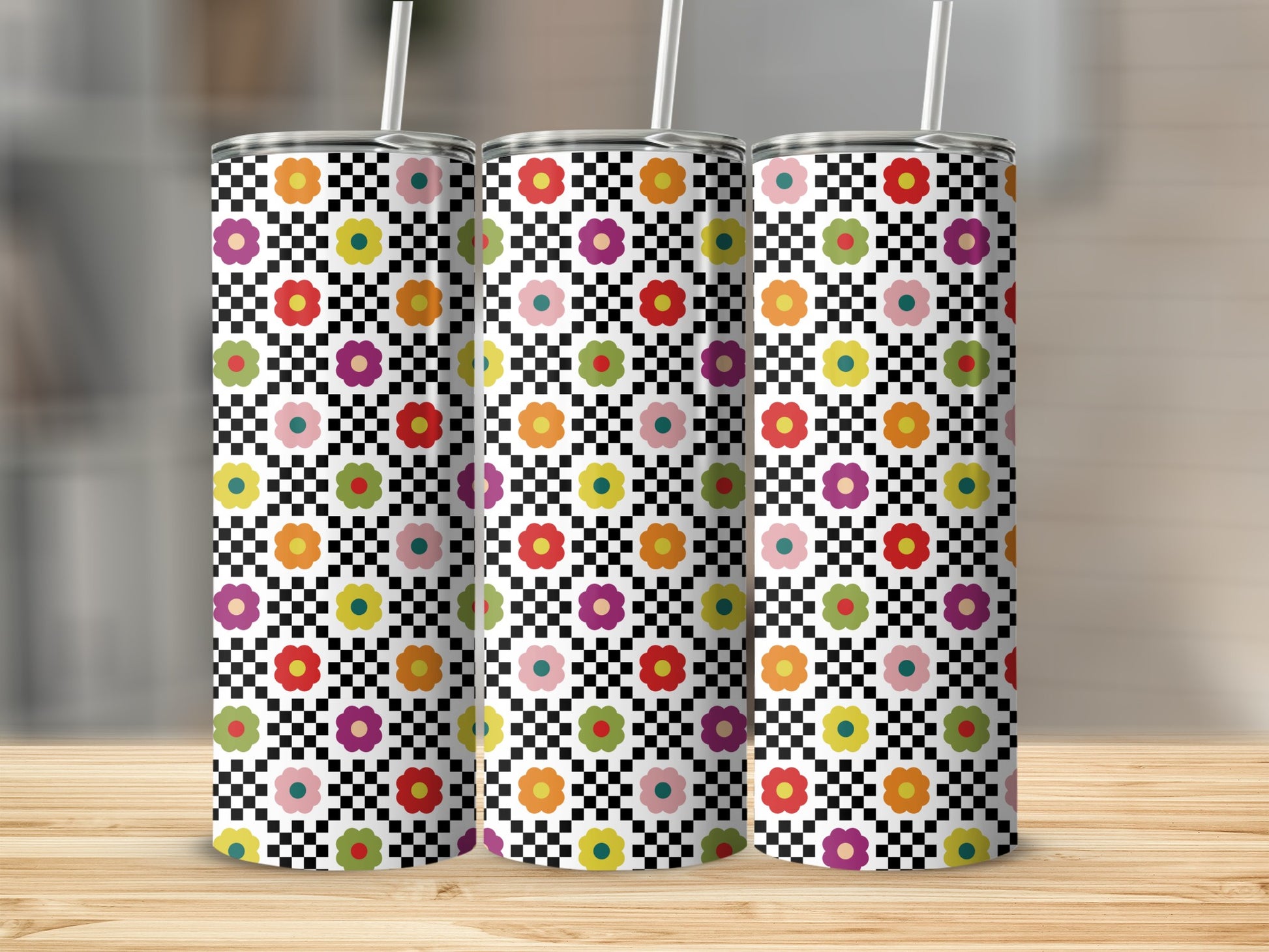 Three tumblers with a black and white checkerboard and colorful floral pattern.