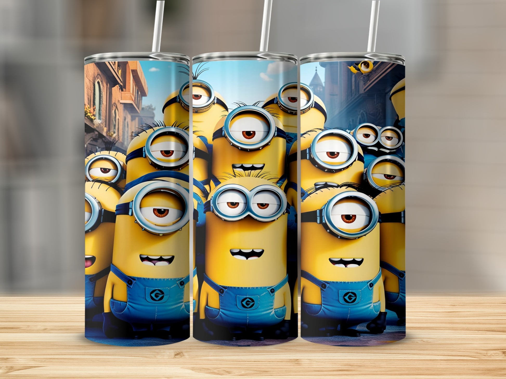 Minions in blue overalls with goggles, stacked as tumblers on a wooden surface.