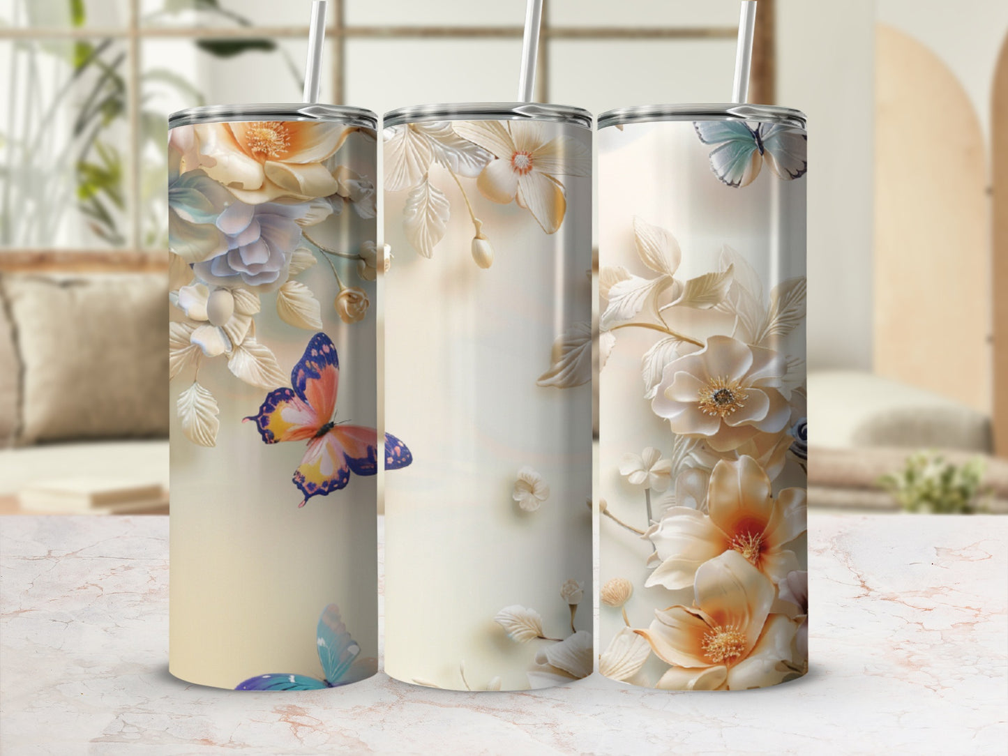 Three tall tumblers with pastel floral and butterfly designs.