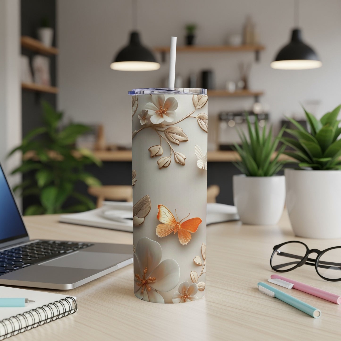 Cream tumbler with embossed floral pattern and orange butterfly.