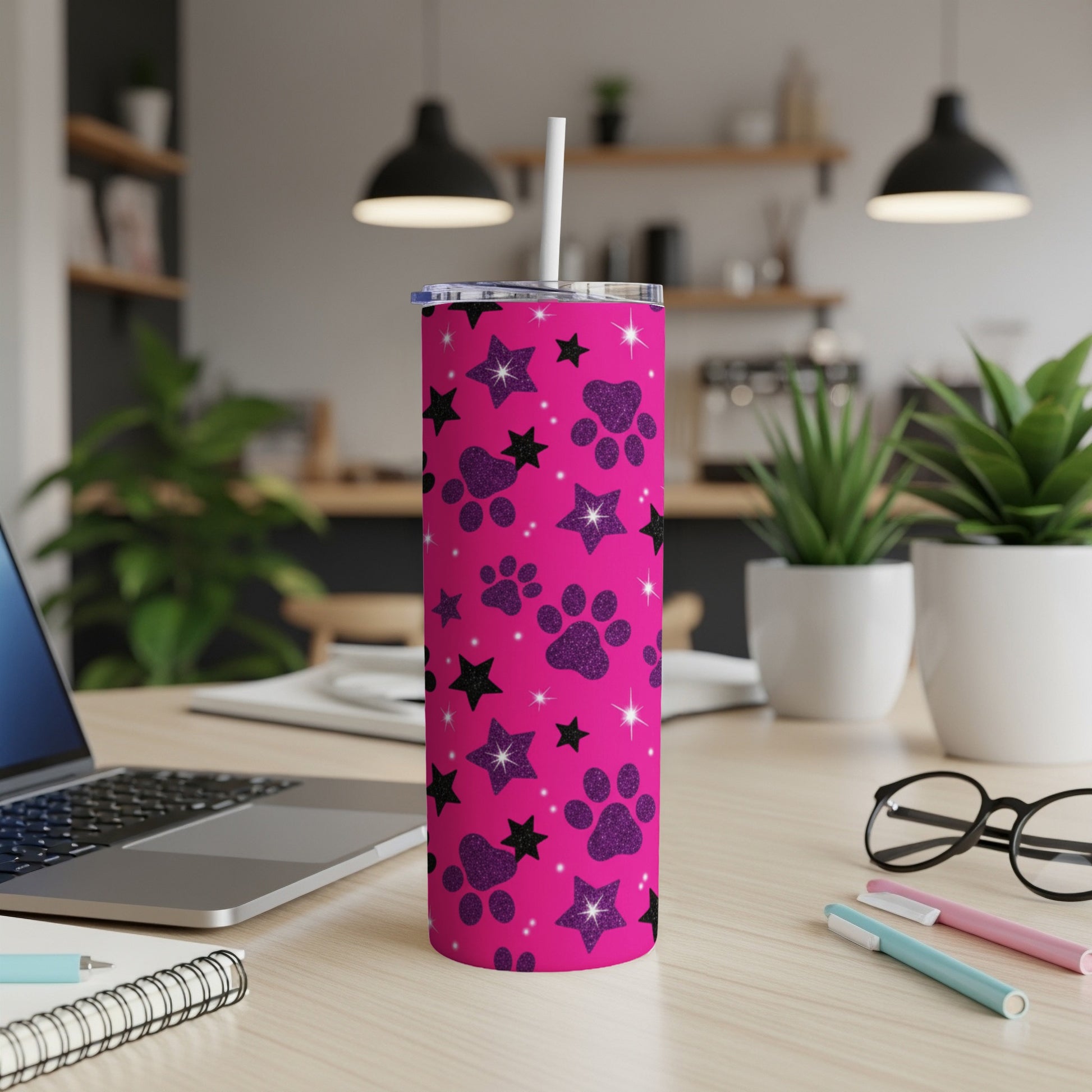 Pink tumbler with black paw prints and stars, includes straw.