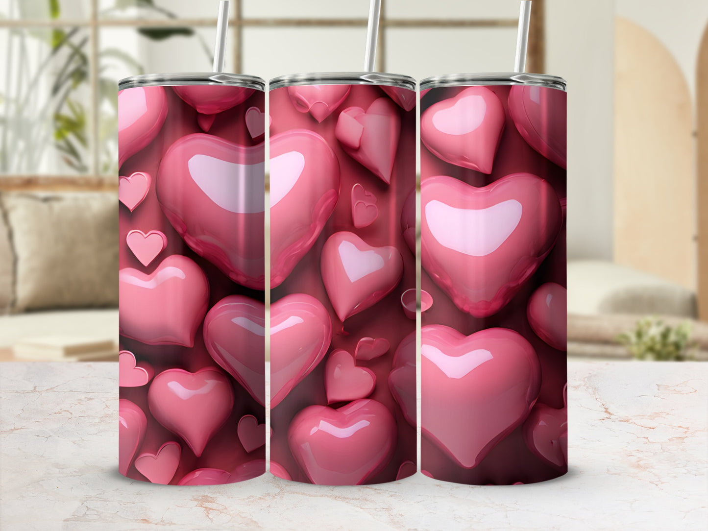 Pink heart pattern on three tumblers with straws.