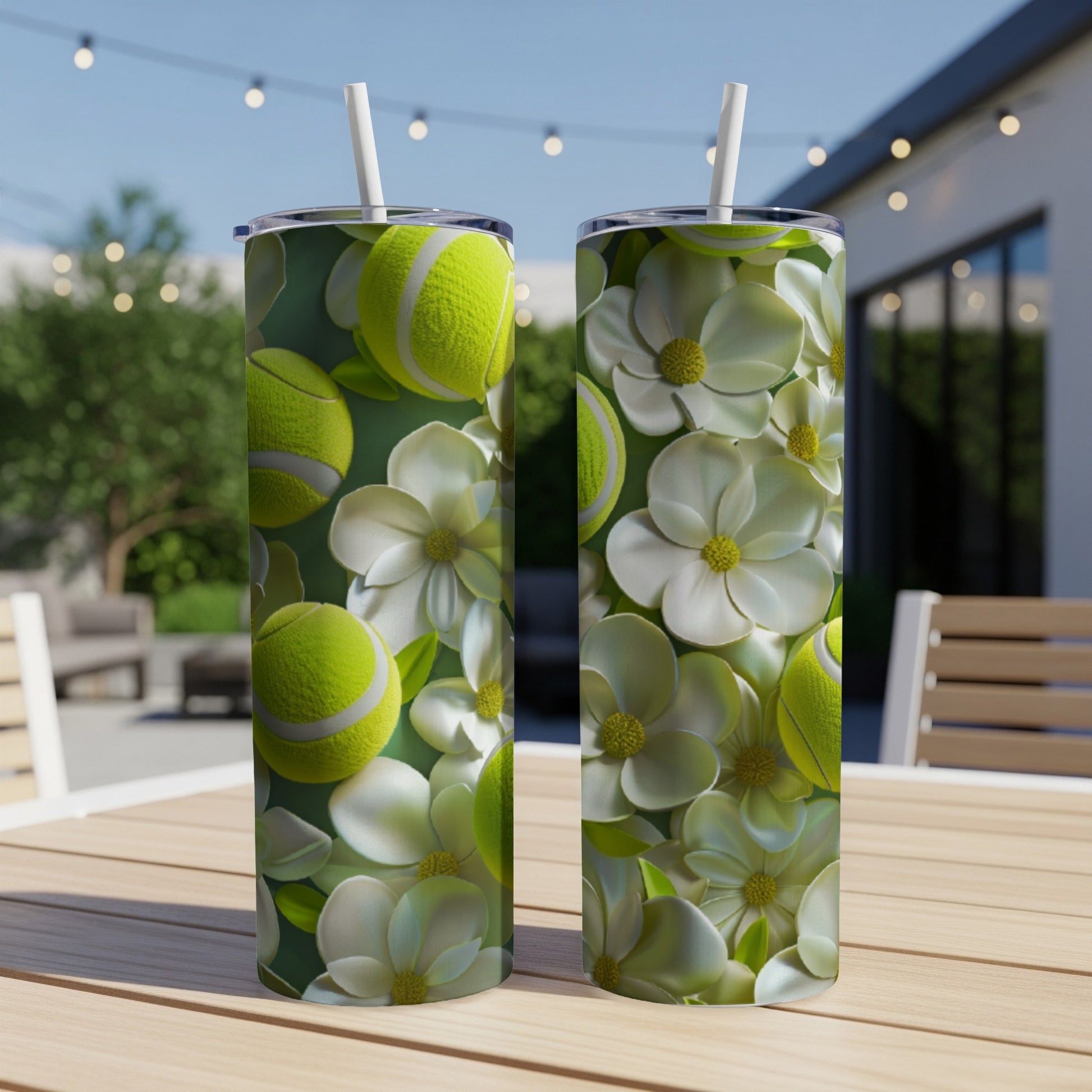 Two tumblers with floral and tennis ball designs on a wooden table.