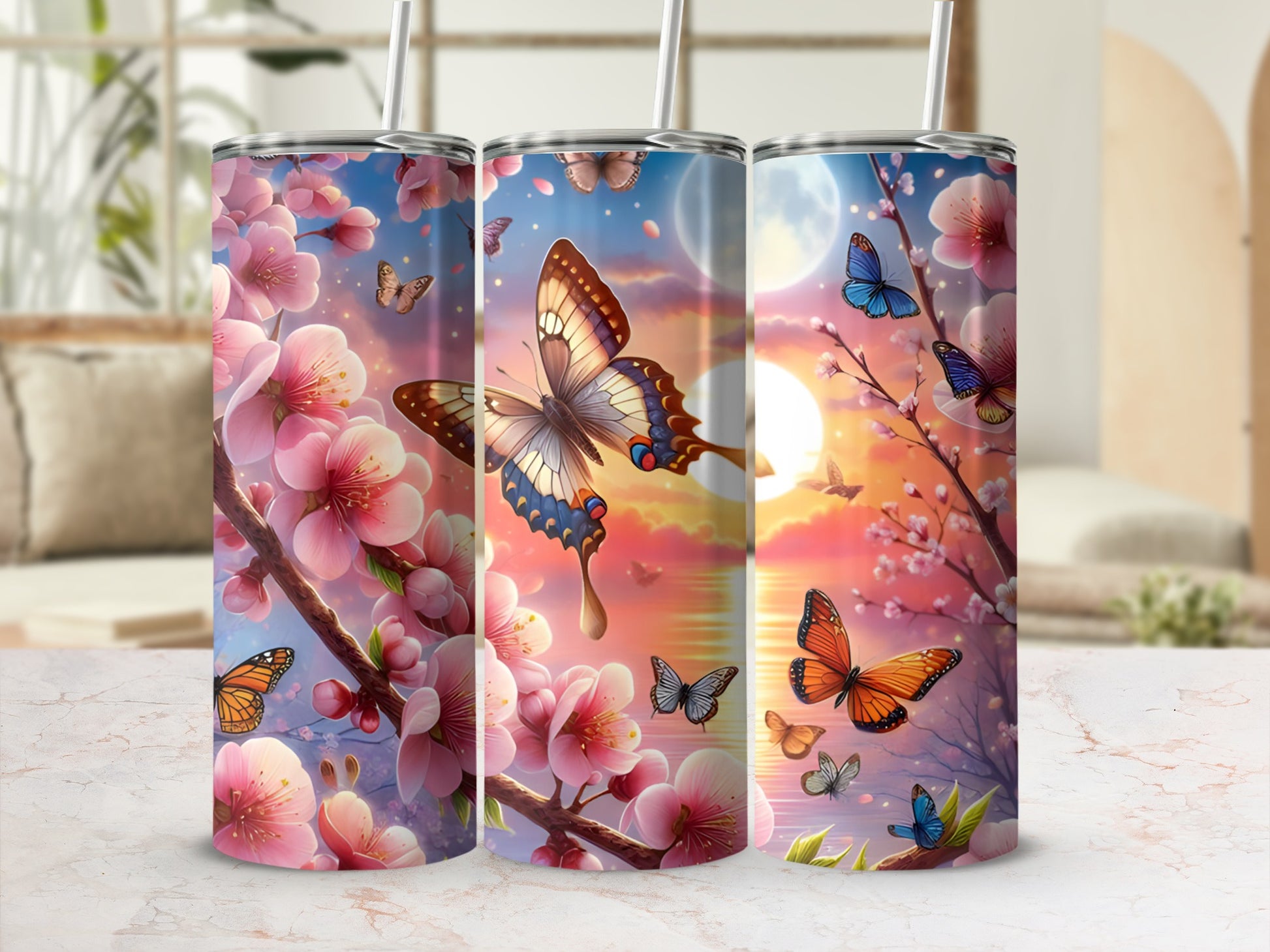 Pink cherry blossoms and butterflies on three tumblers against a soft, sunset background.