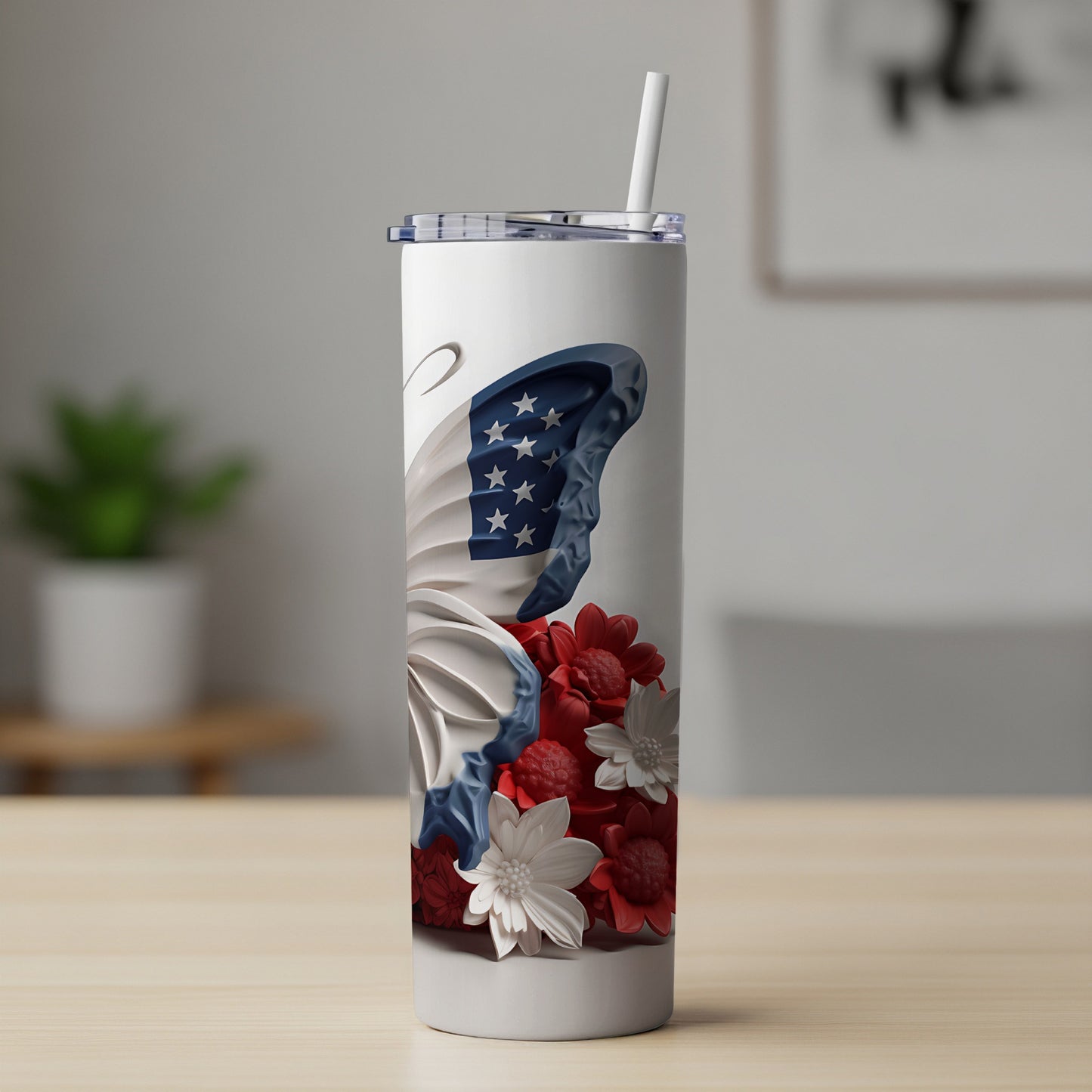 White tumbler with butterfly wings featuring American flag pattern and red and white flowers.