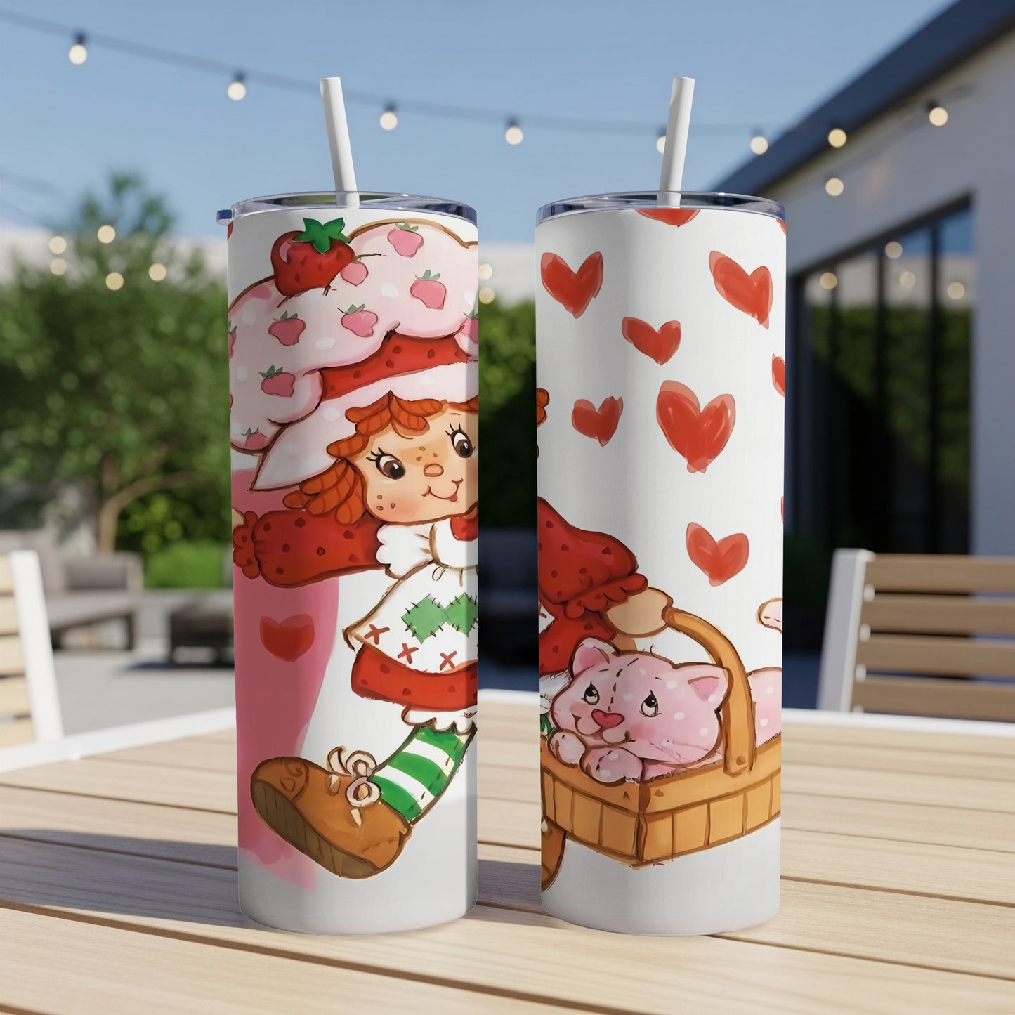 Strawberry Shortcake character with a pink cat in a basket on a tumbler.