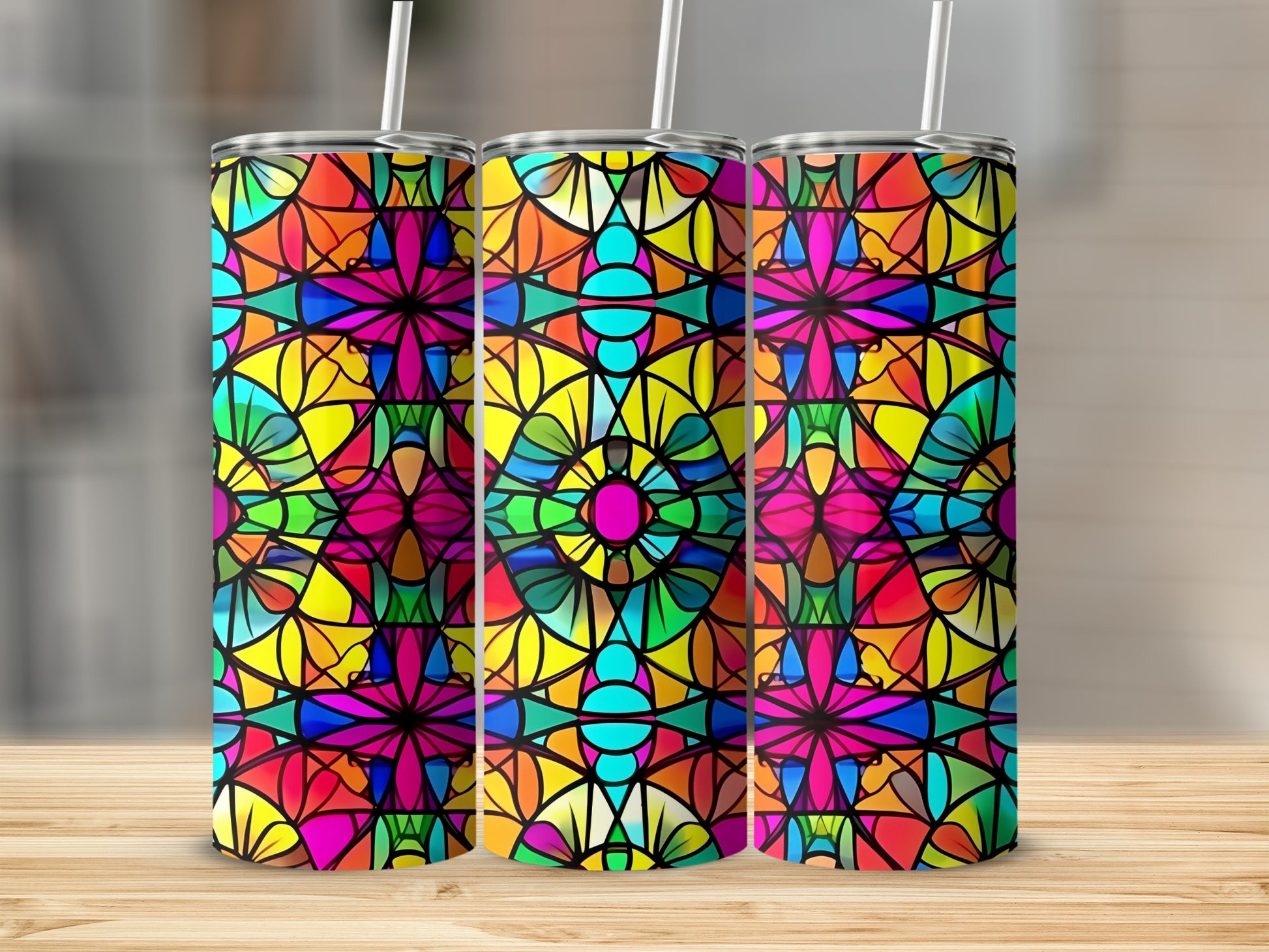 Three stained glass tumblers with colorful geometric patterns.