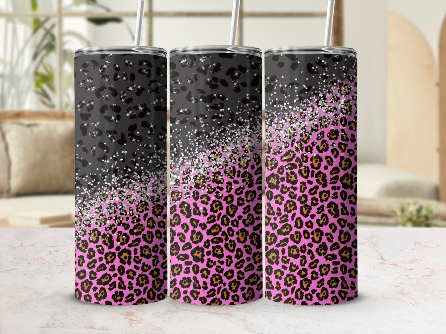 Three tumblers with leopard print and glitter accents.