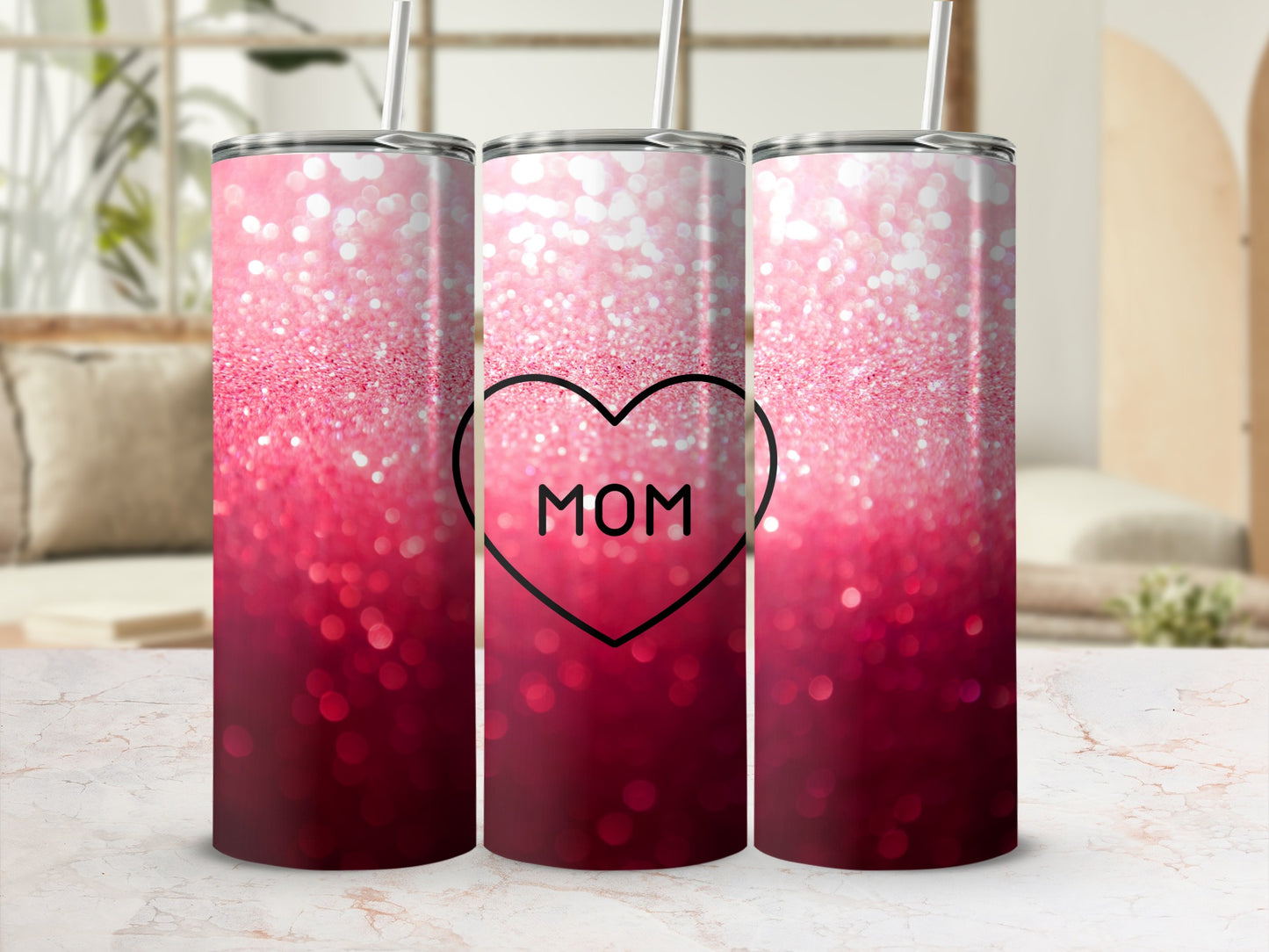 Pink and red ombre glitter tumbler with "MOM" in a black heart.