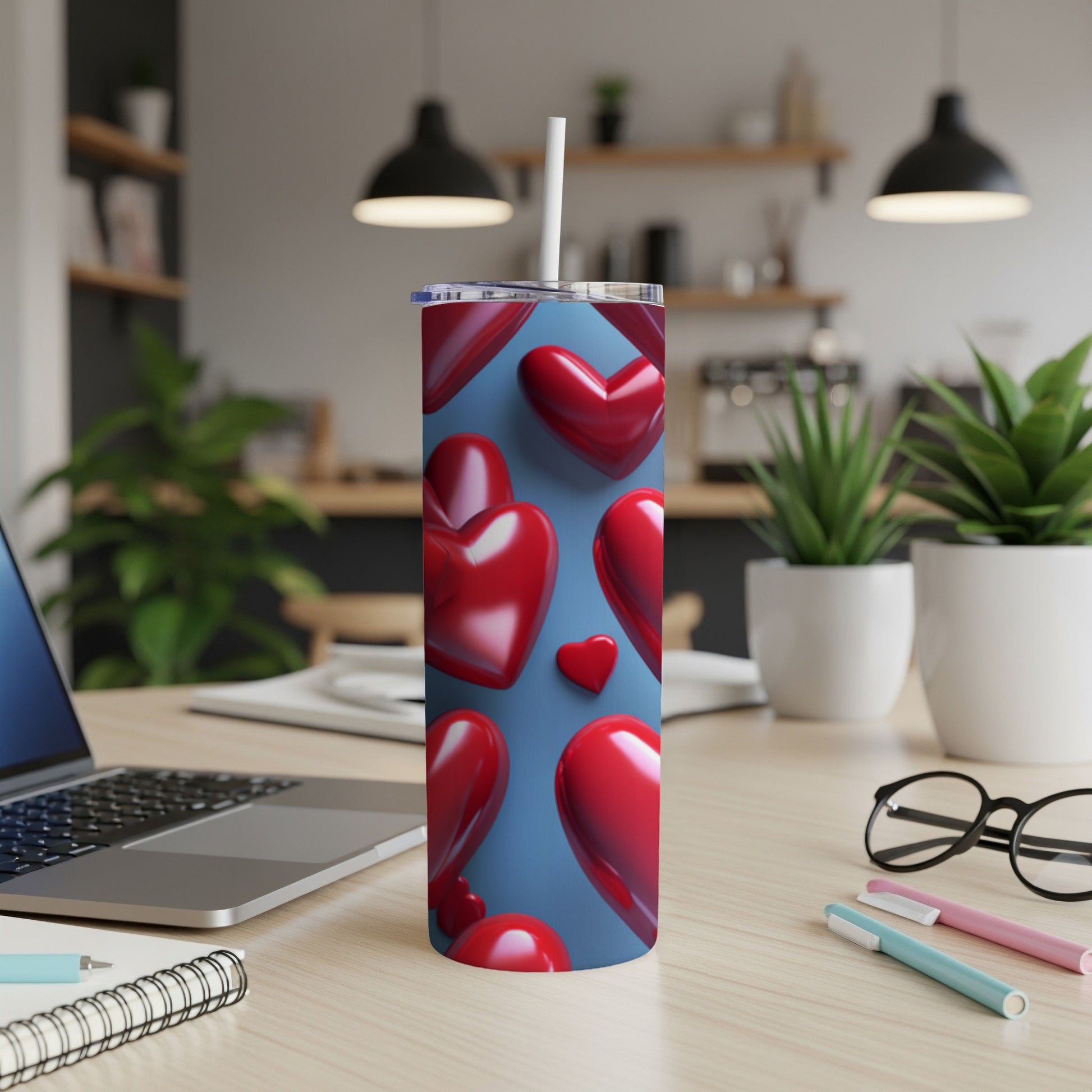 Red hearts pattern on a blue background wraps a tall, slender tumbler.
