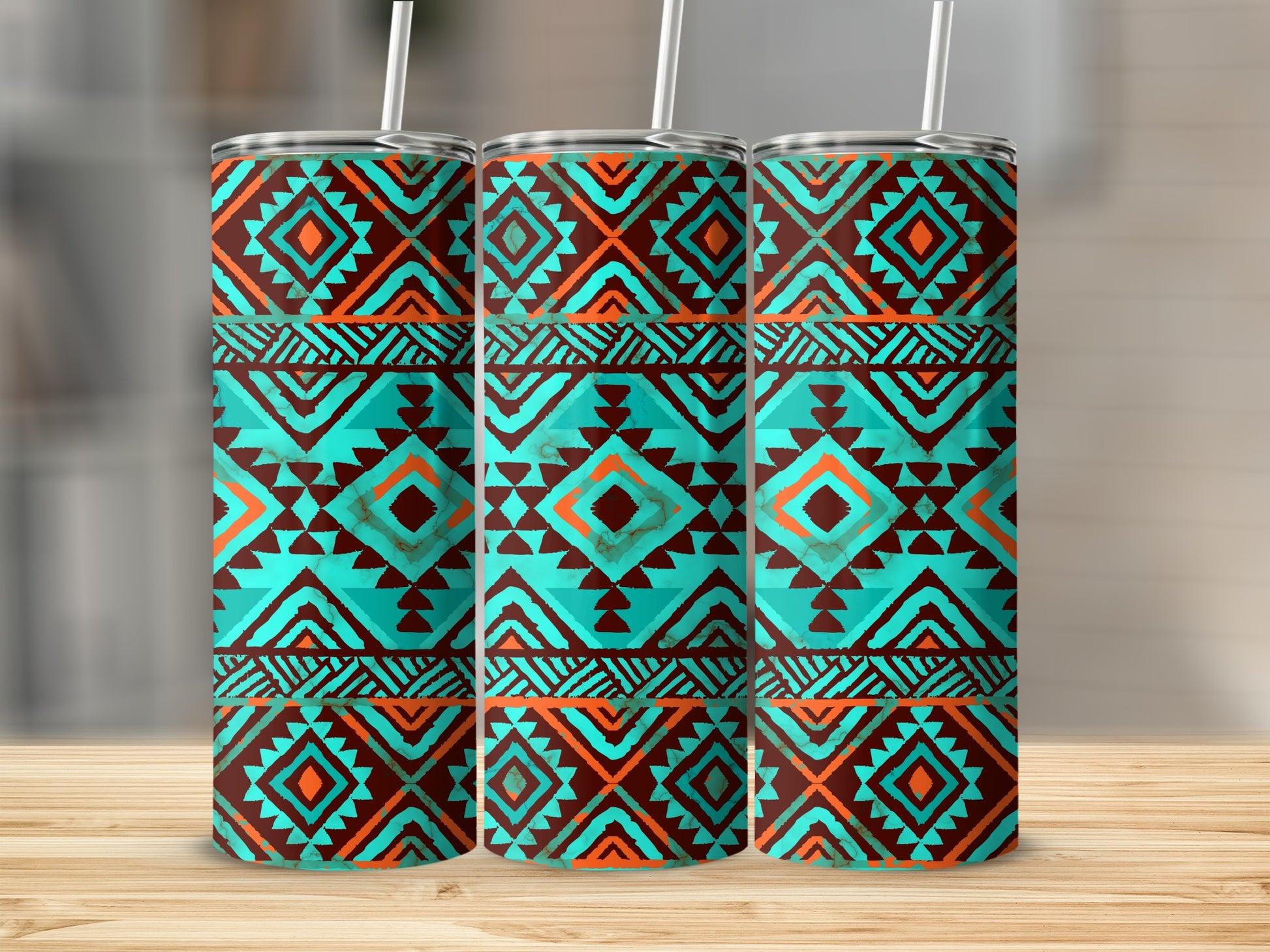 Three tumblers with a geometric turquoise, orange, and brown tribal pattern.