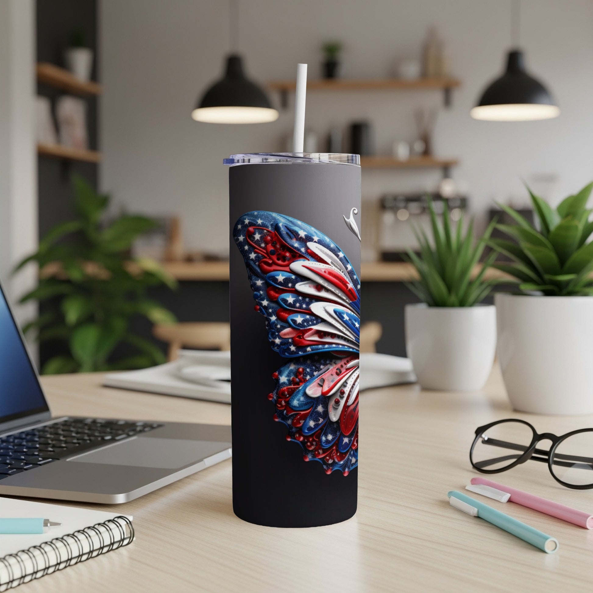 Black tumbler with American flag butterfly design and straw.