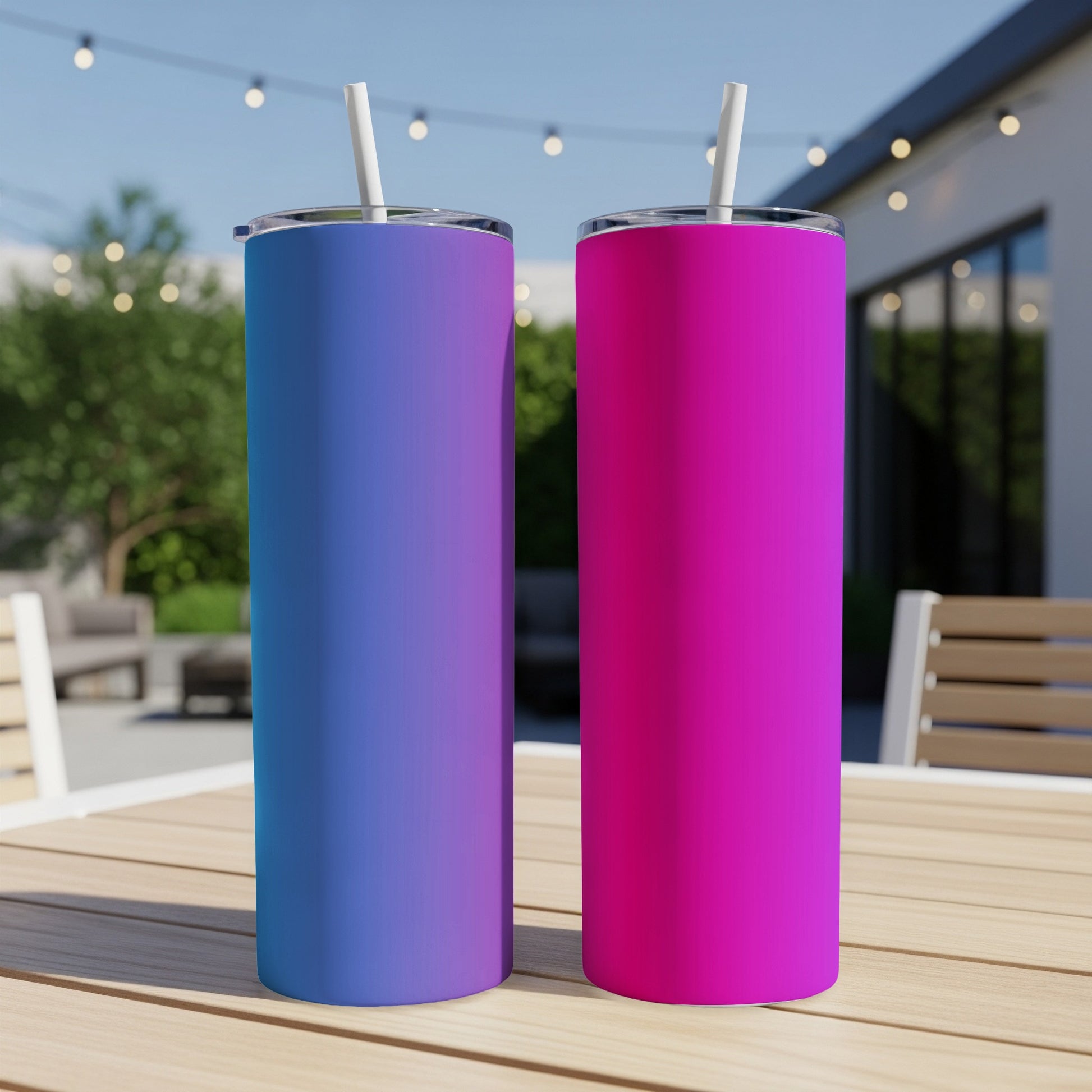 Two gradient tumblers, blue to purple and pink, on a wooden table.