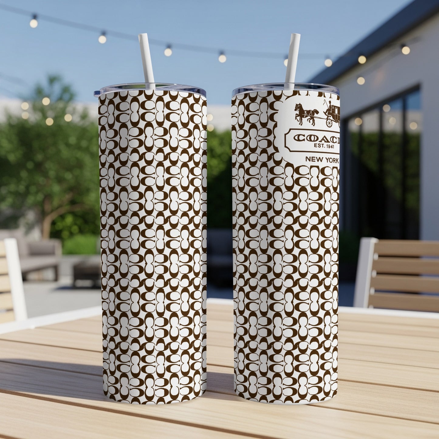 Coach New York tumbler with brown and white monogram pattern and straw.