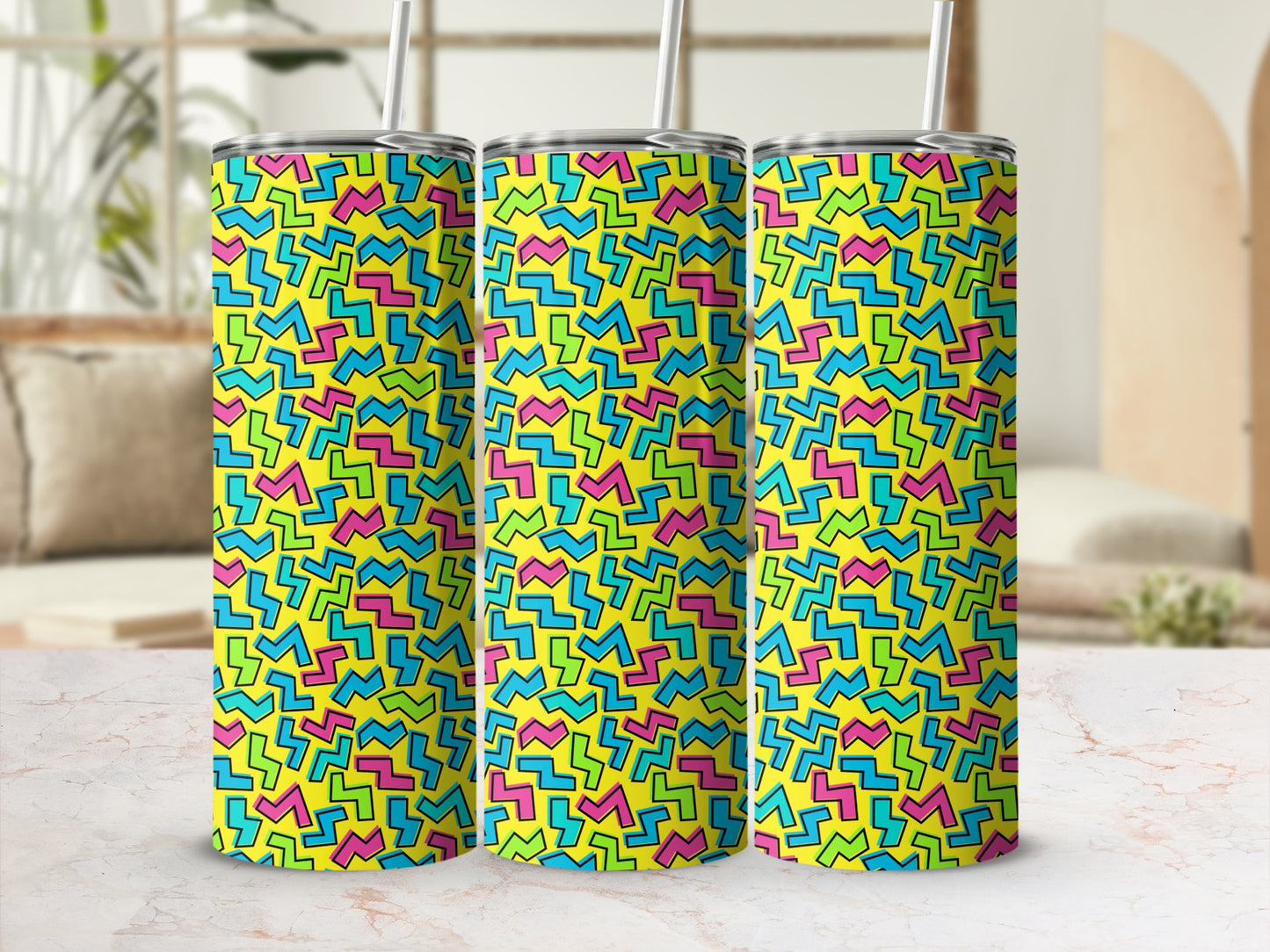 Three tumblers with a yellow background and scattered geometric shapes in pink, blue, and green.