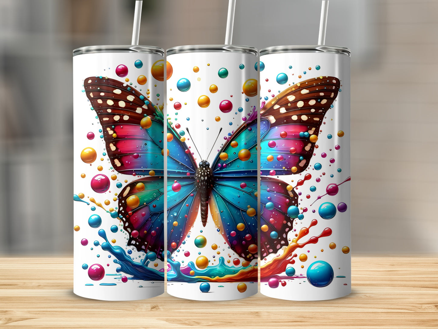 Three colorful tumblers featuring a butterfly and vibrant bubble splash design.